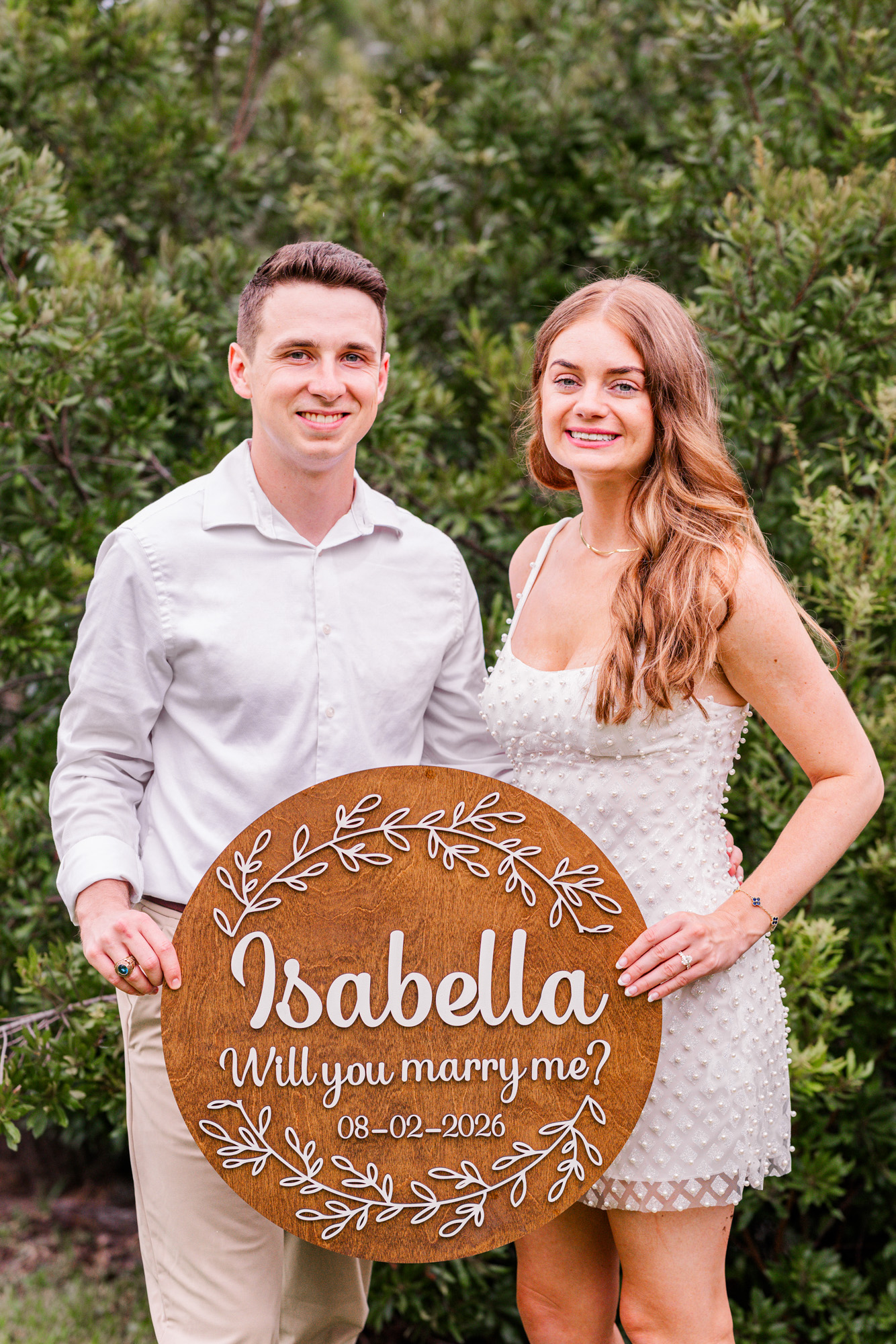 couple holding a custom sign