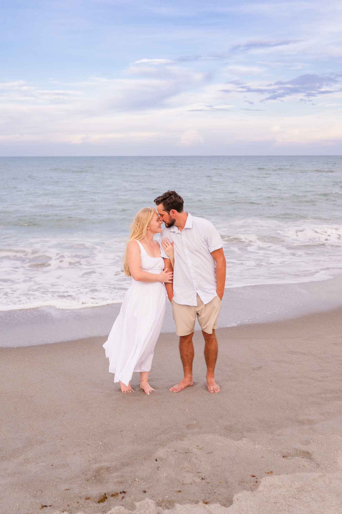 Man kissing head of woman on Melbourne Beach