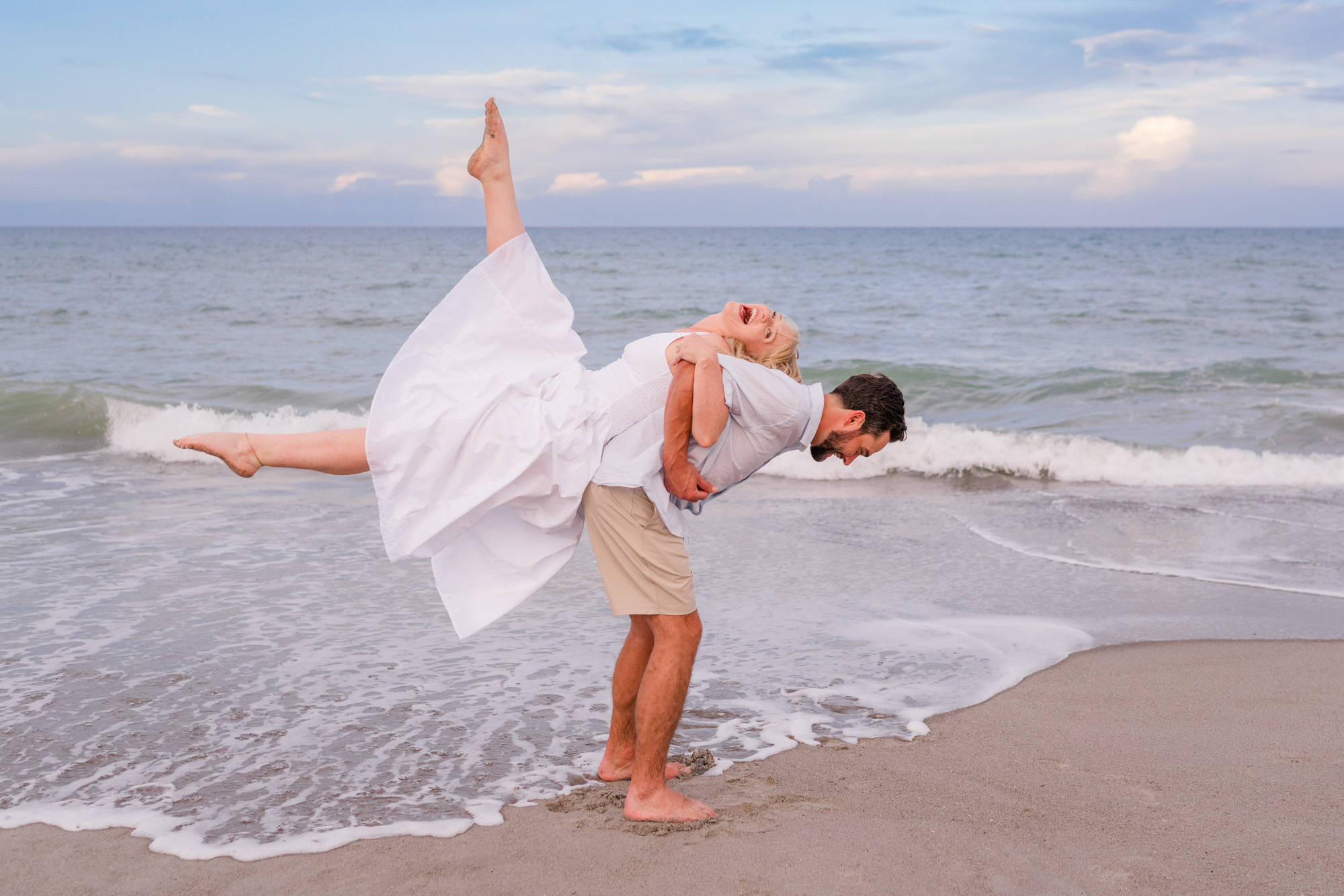 Man lifting woman on his back on Melbourne Beach