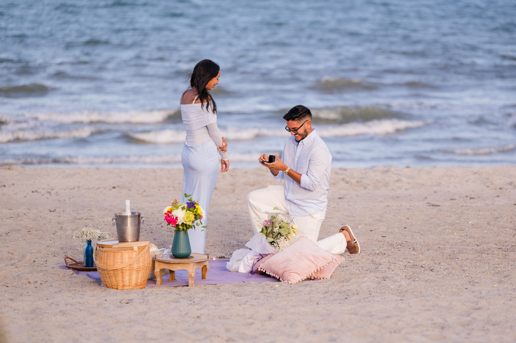 Man down on one knee asking his girlfriend to marry him