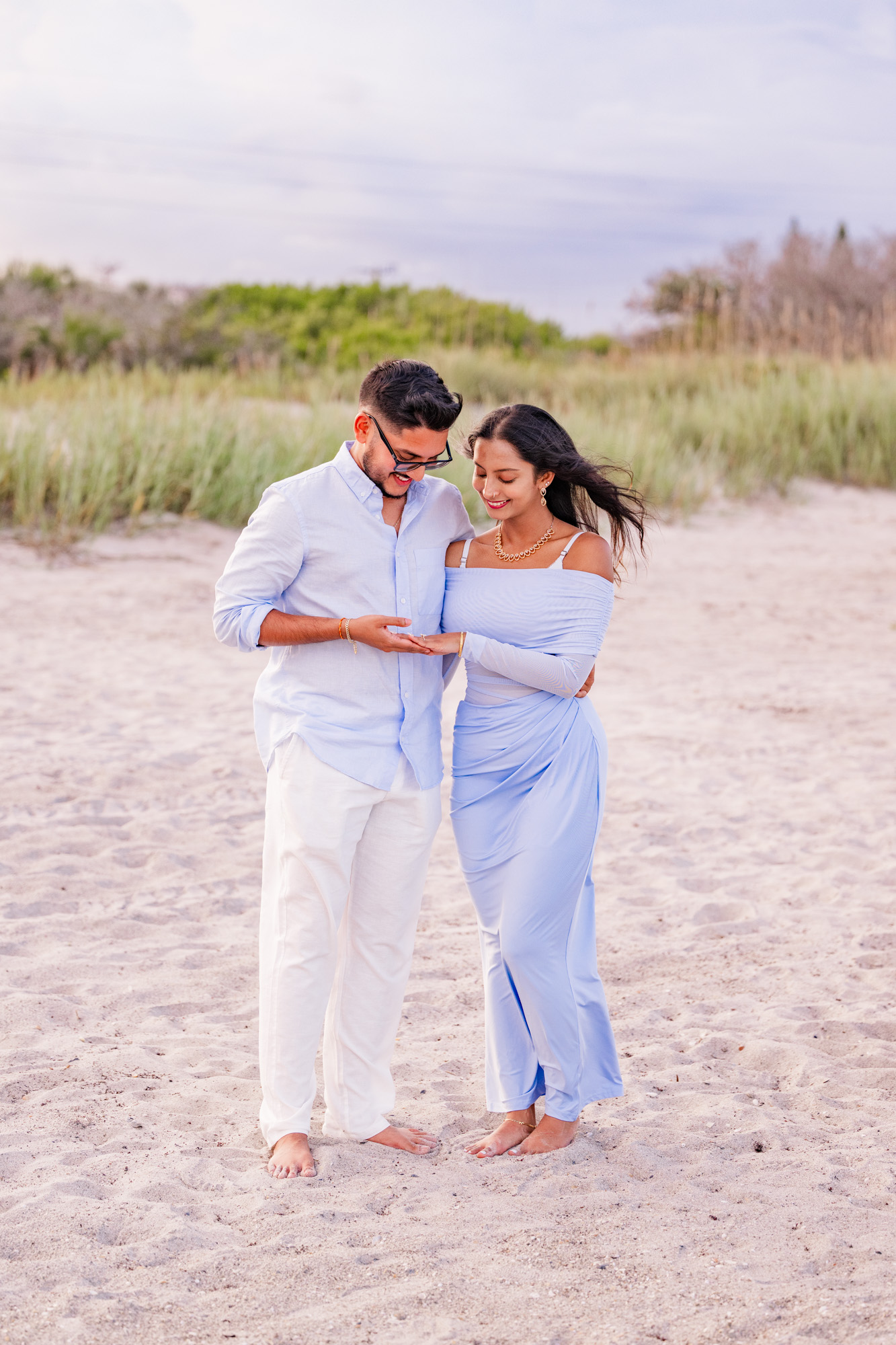 Man and woman looking at engagement ring on Cocoa Beach