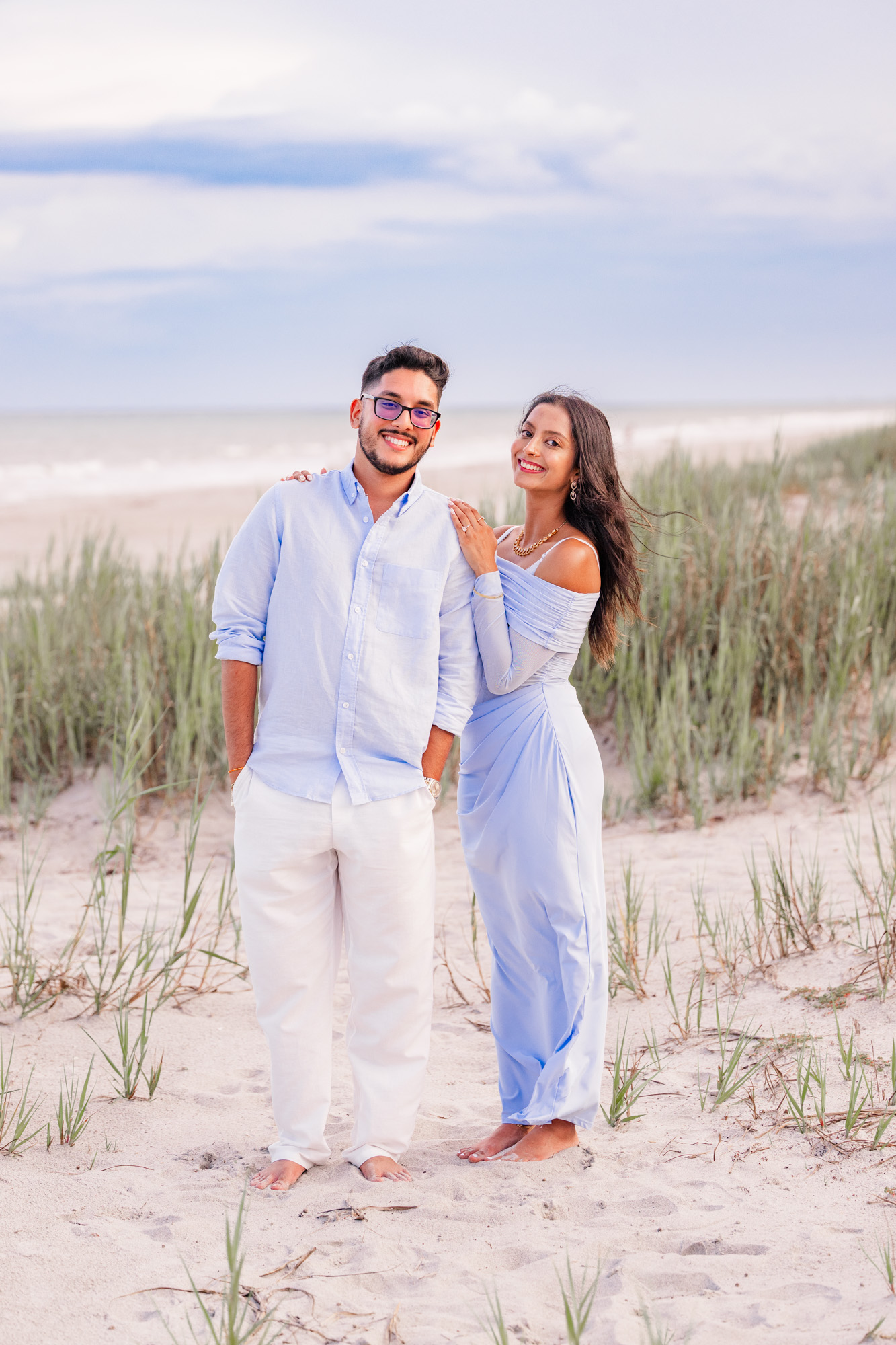 couple dressed in blue and white hugging