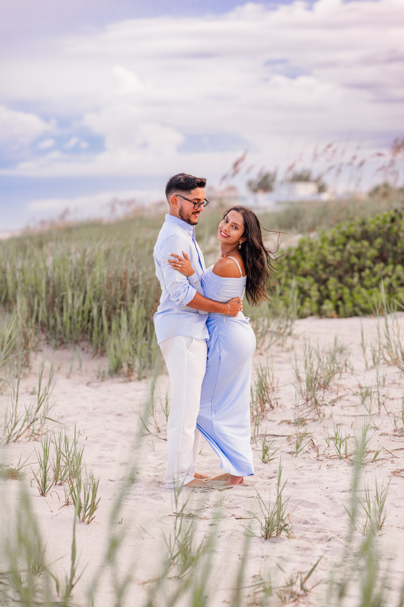 couple in dunes on Cocoa Beach after getting engaged