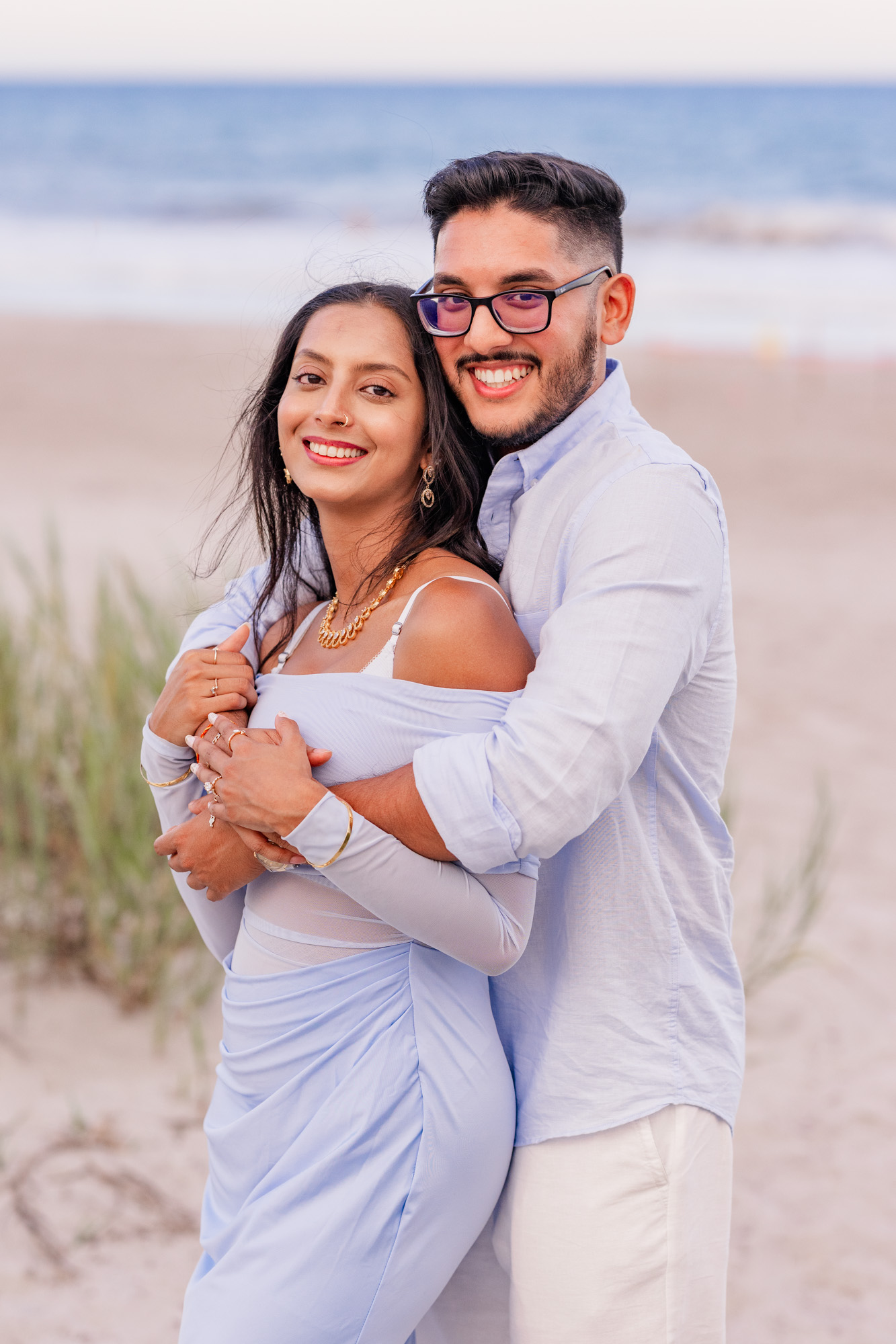 man hugging woman from behind on Cocoa Beach