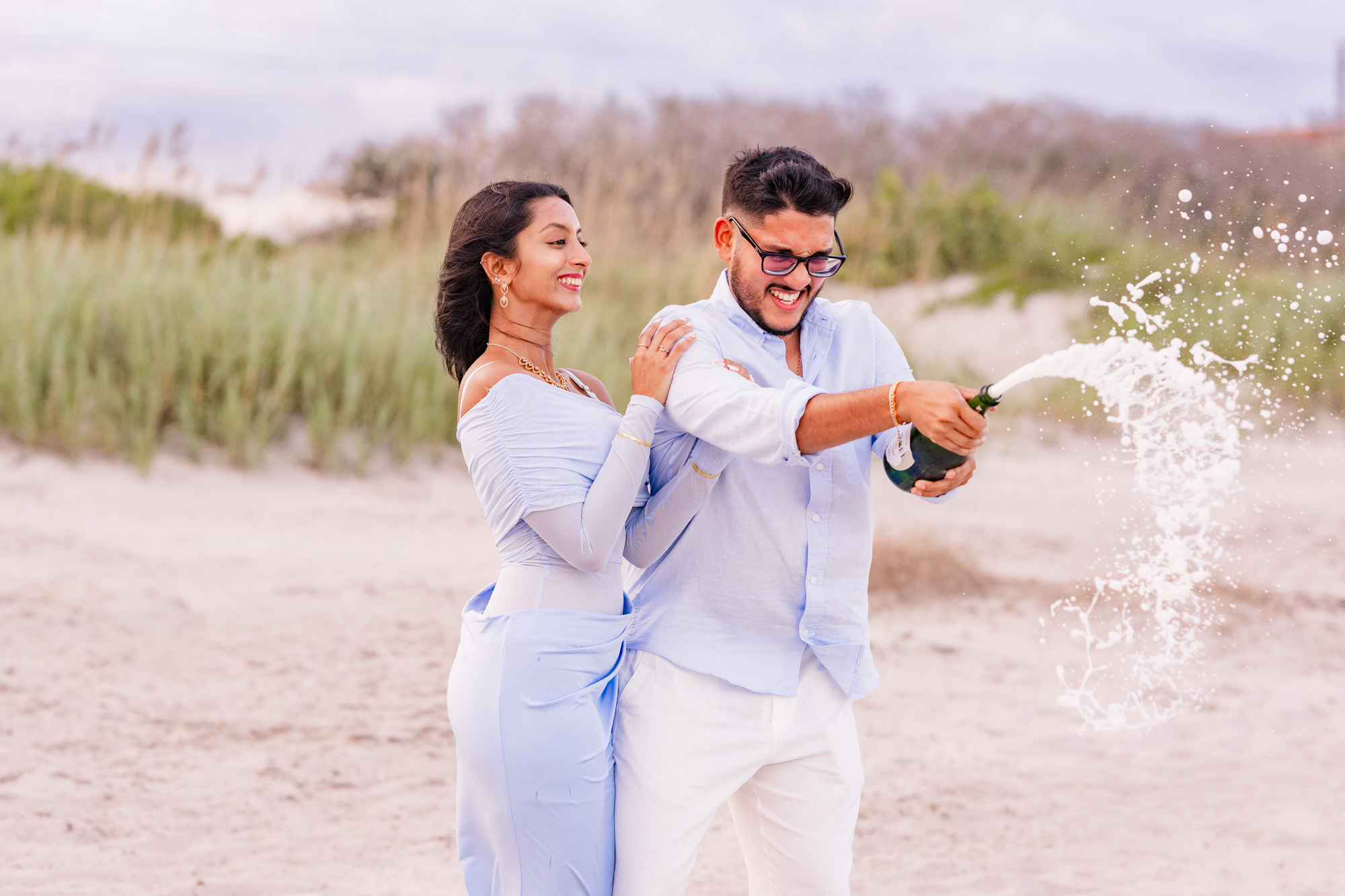 Man spraying champagne after getting engaged