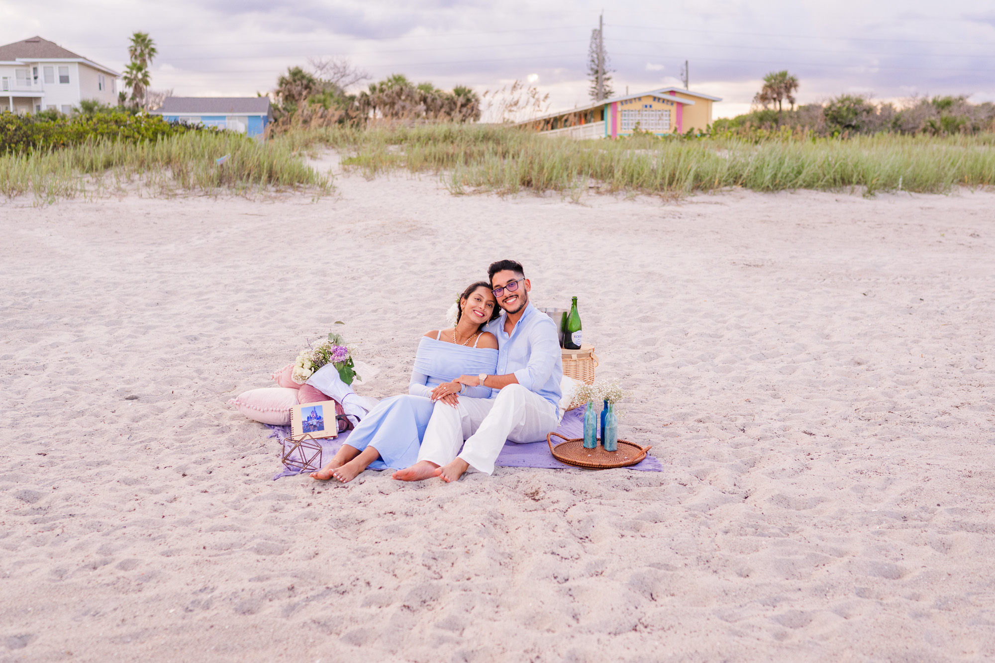couple sitting on blanket on Cocoa Beach