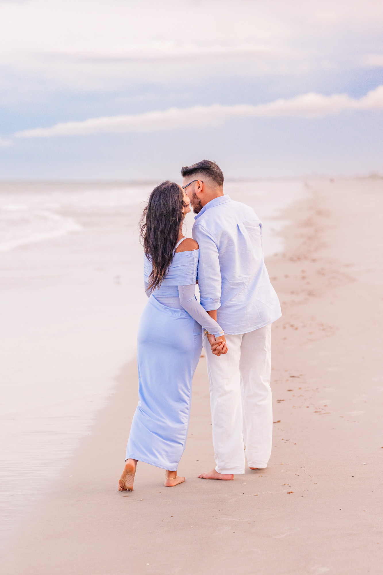 Man and woman kissing by the ocean on Cocoa Beach
