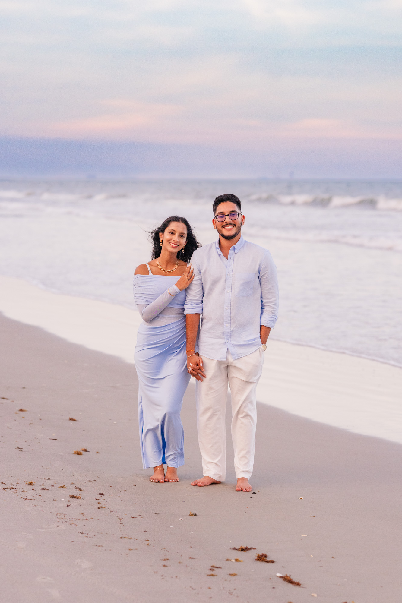 Woman snuggling on man while walking down Cocoa Beach, Florida