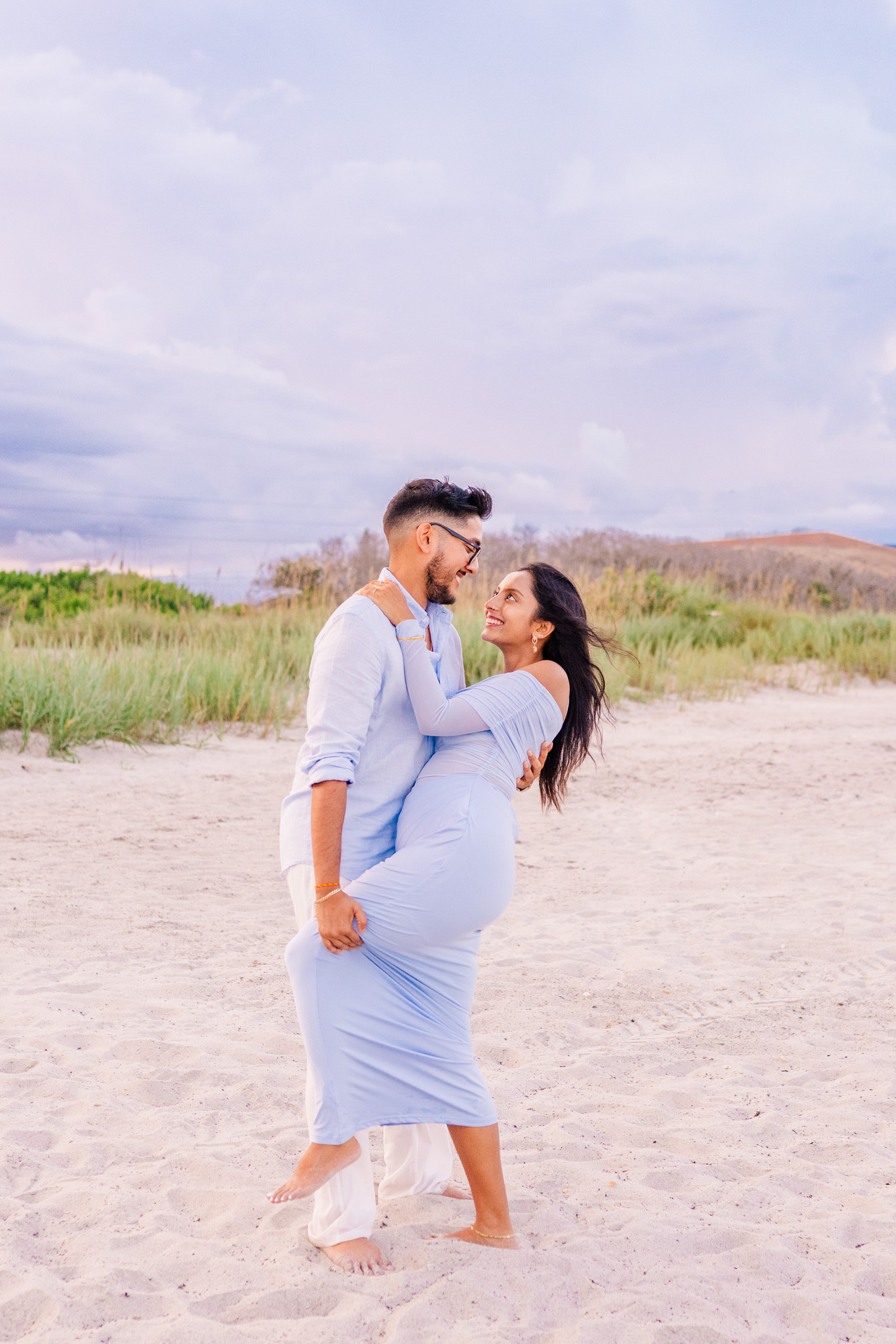 Man dips woman in blue after asking her to marry him on Cocoa Beach
