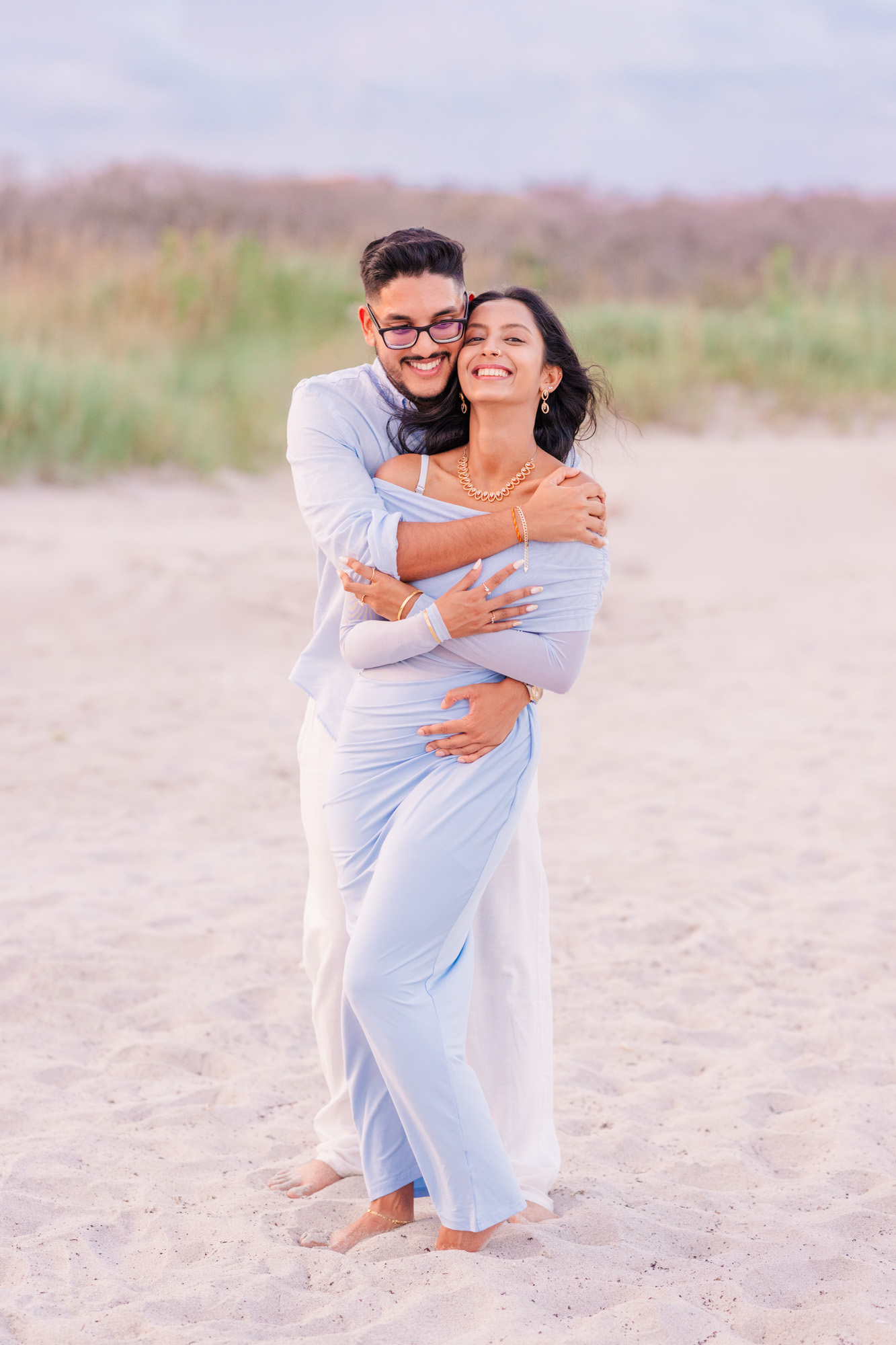 man hugging woman from behind after he asked her to marry hime