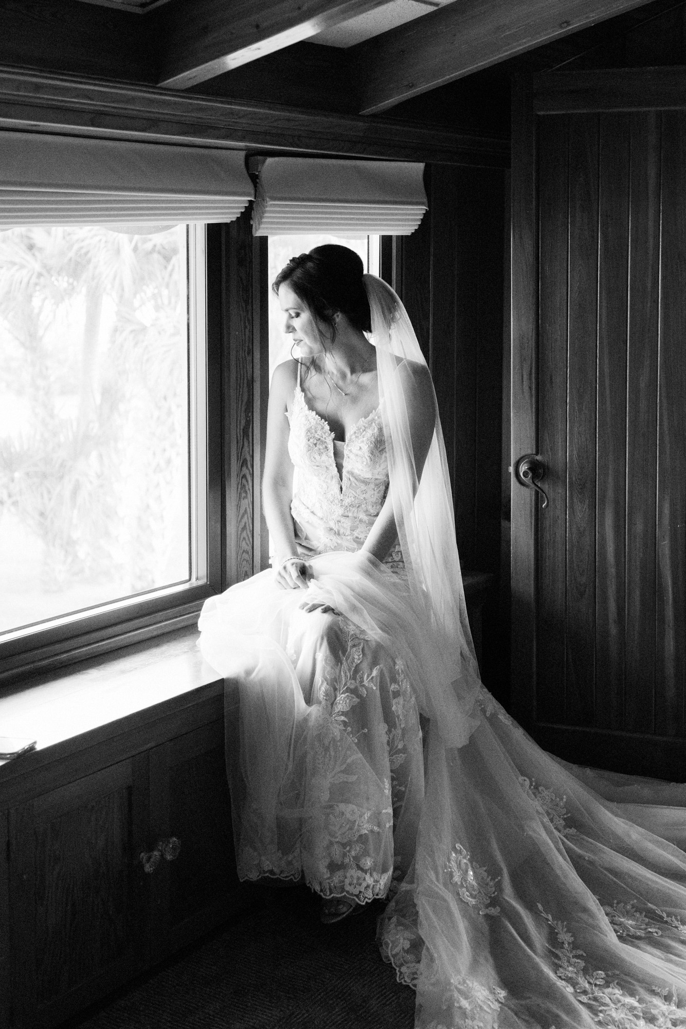 Black-and-white bridal portrait by a window inside Estate on the Halifax.