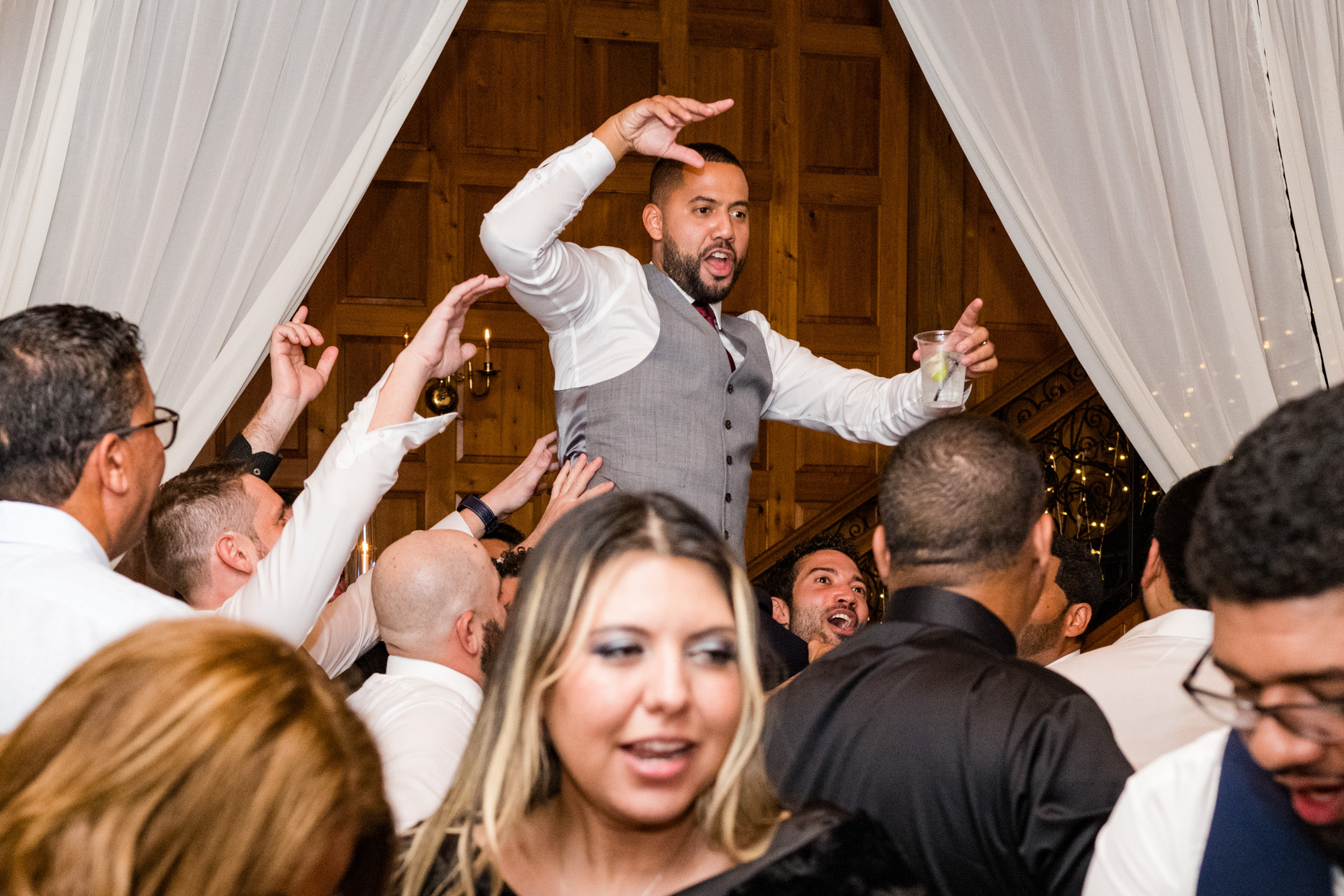Groom lifted above the crowd while dancing at the Estate on the Halifax wedding reception.