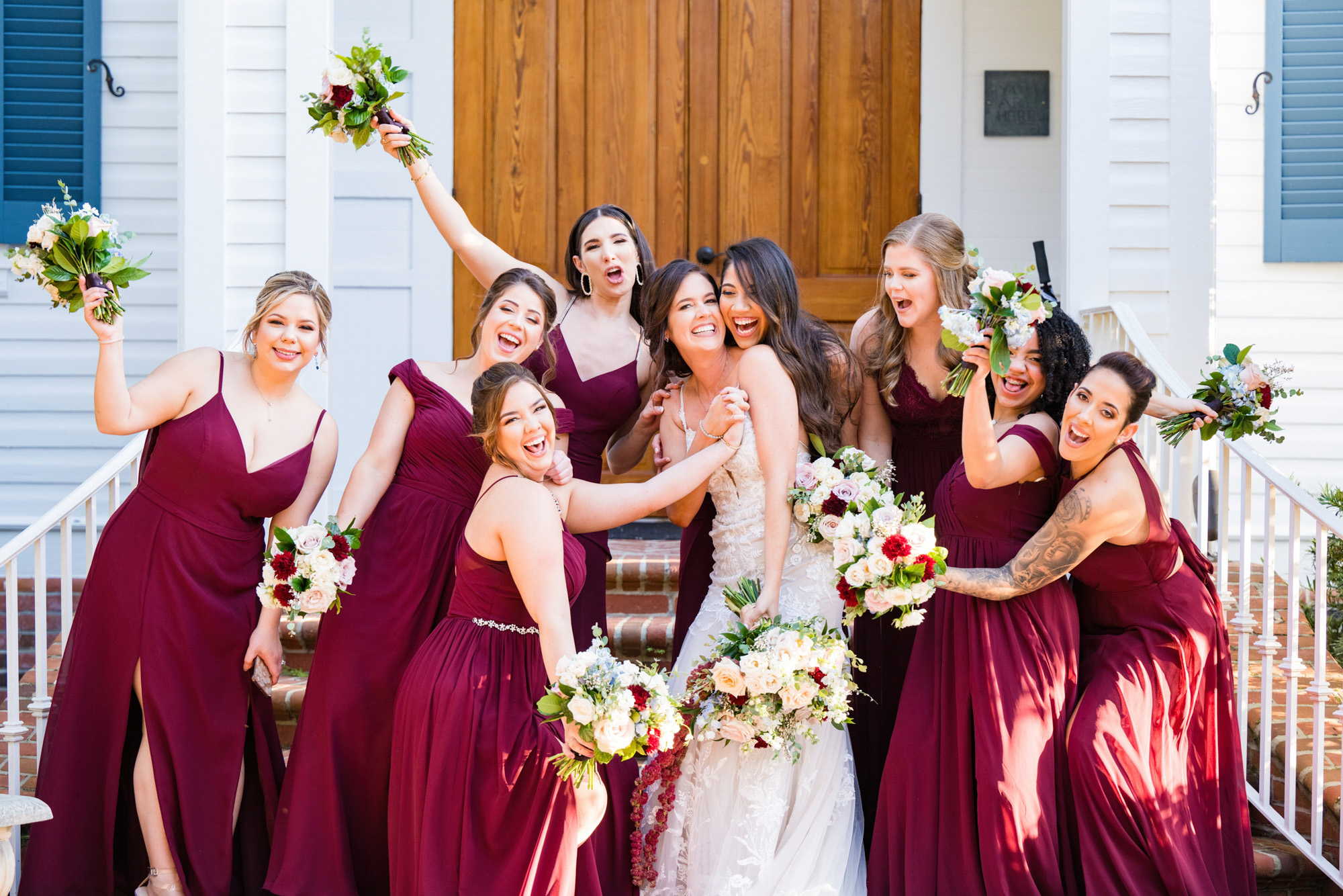 Bride celebrating with her bridesmaids outside the chapel at Estate on the Halifax.
