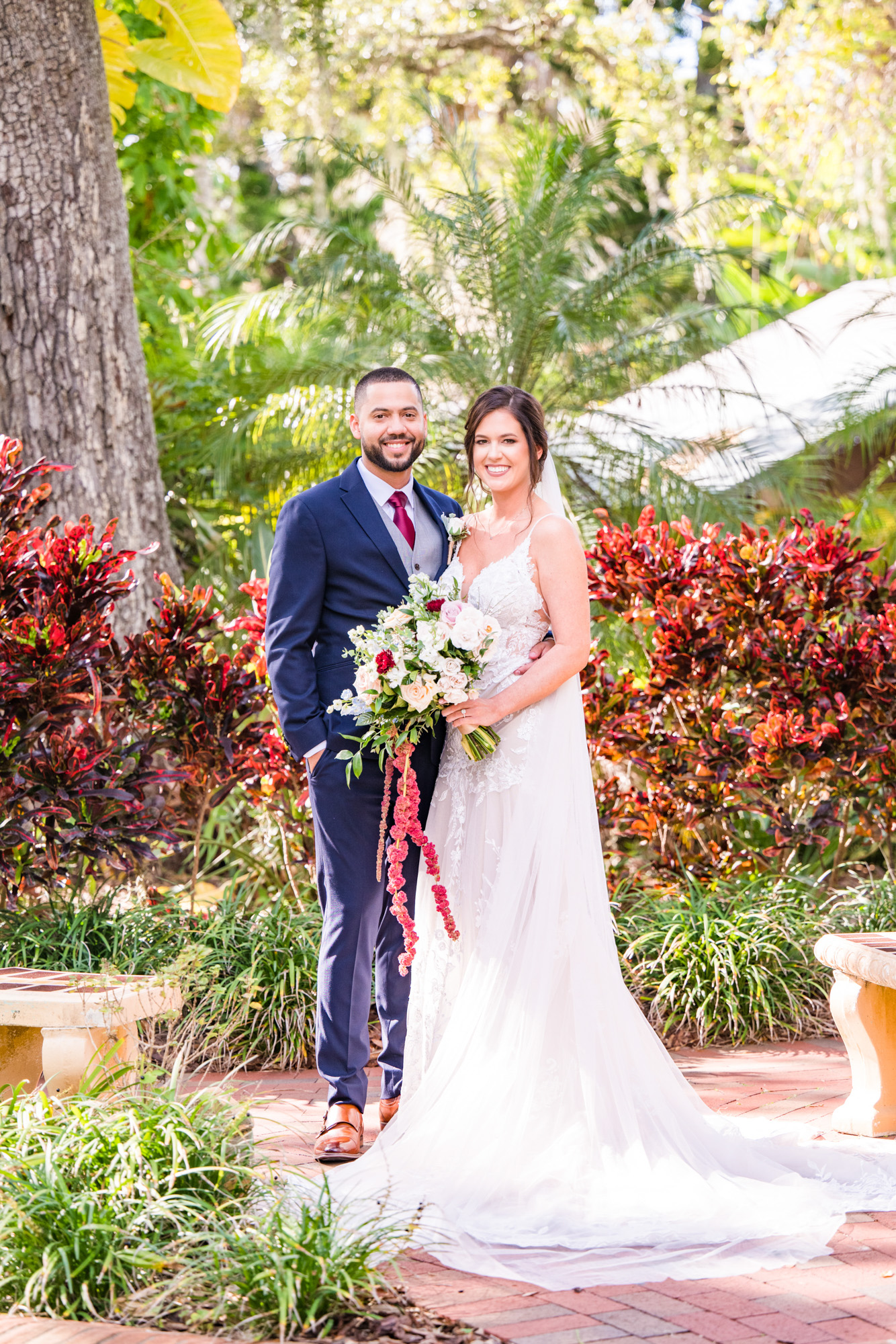 Bride and groom posing together in the lush gardens at Estate on the Halifax in Port Orange.