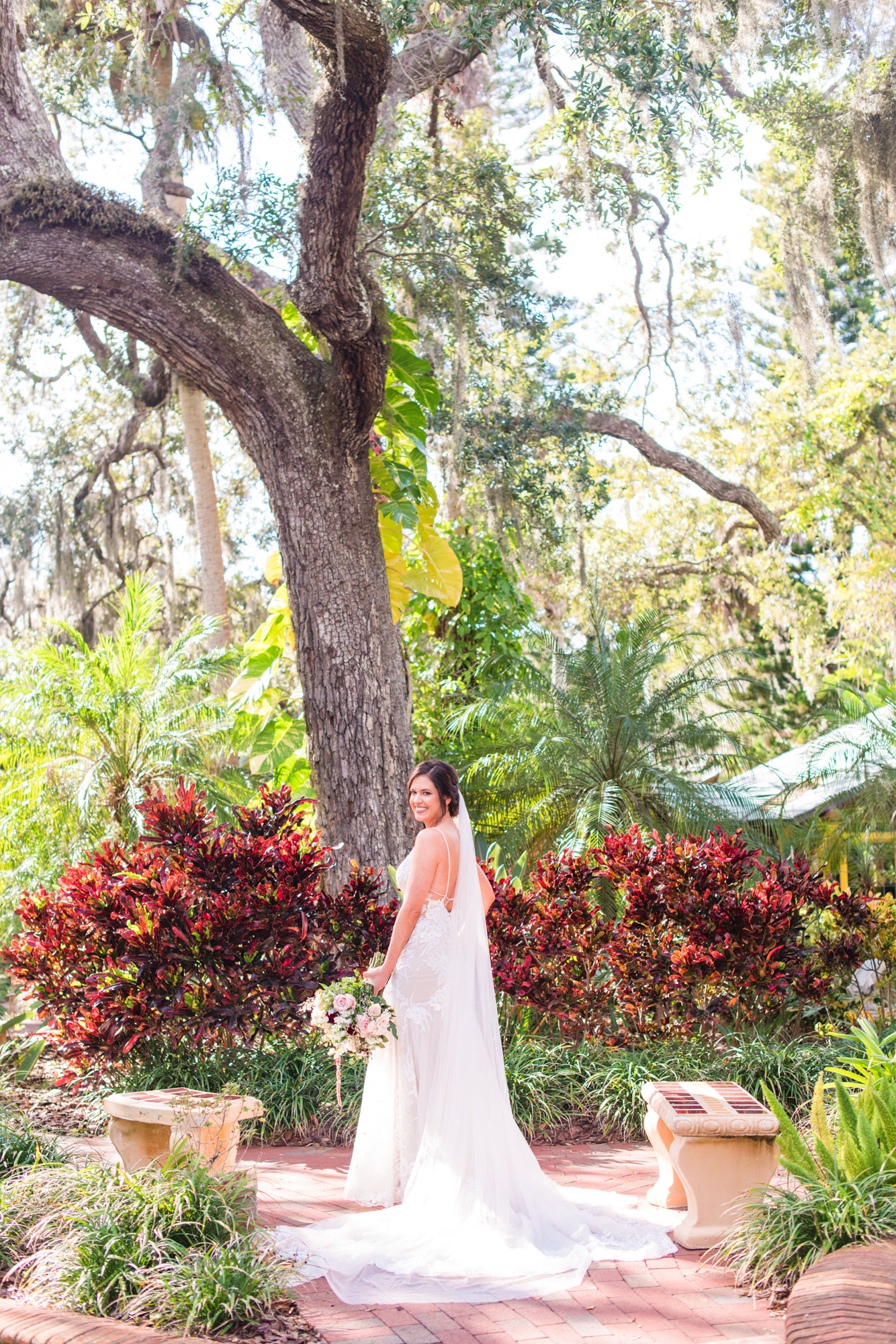 Bride laughing while holding a colorful floral bouquet during her Estate on the Halifax wedding.