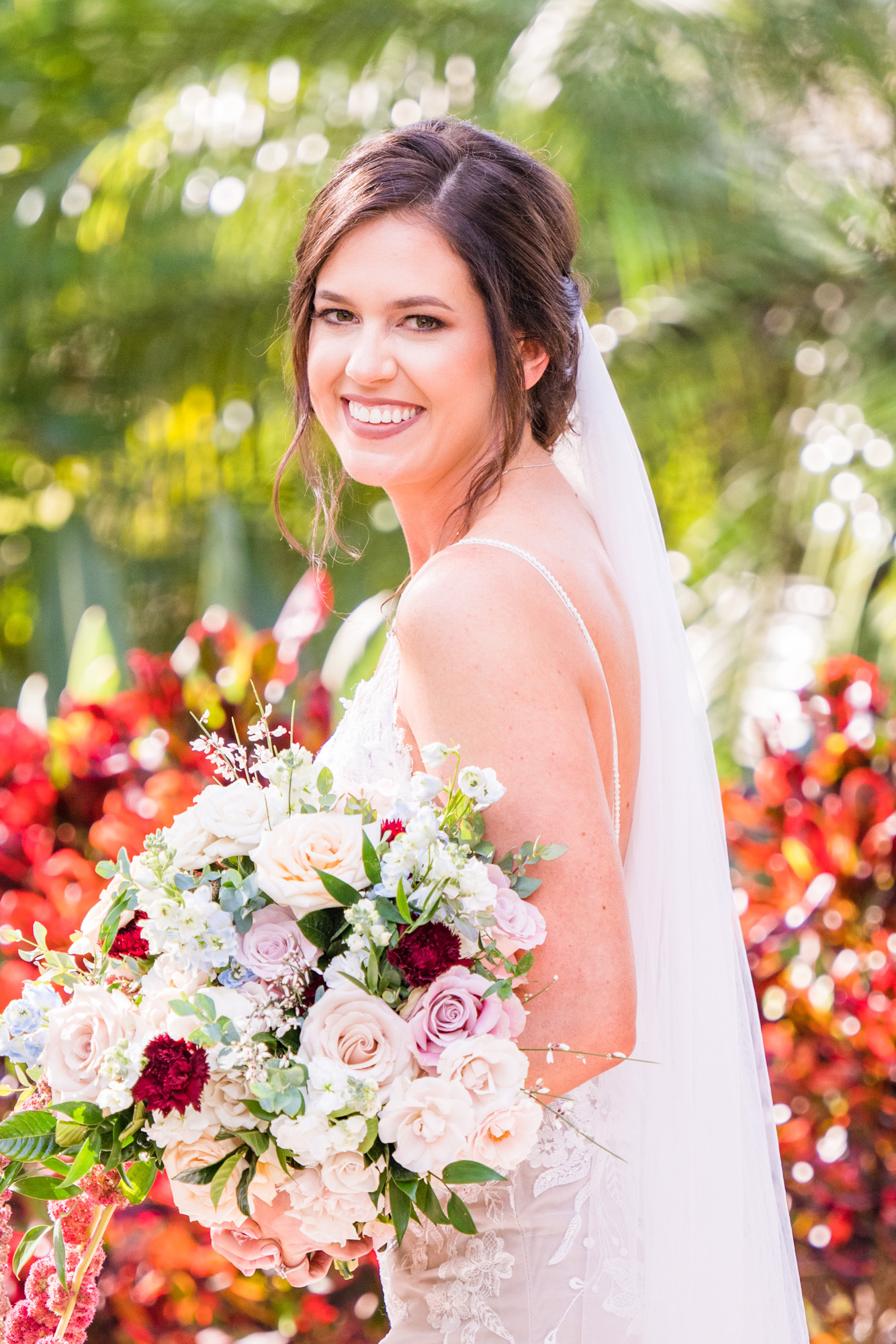 Bride standing beneath a large oak tree for a full-length bridal portrait at Estate on the Halifax.