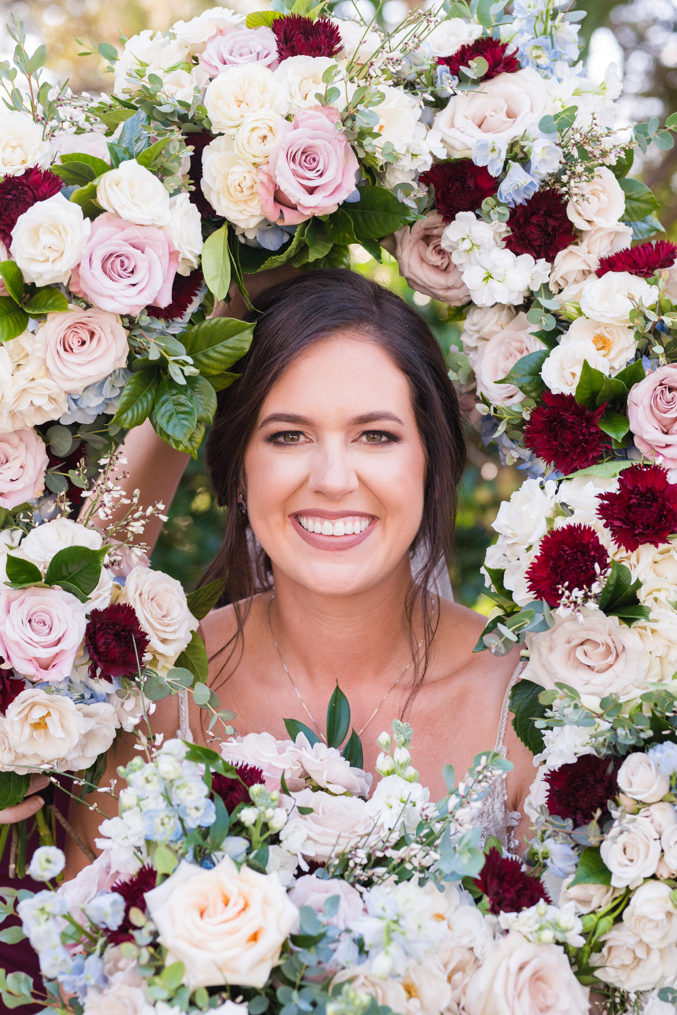 Bride with all of the bouquets around her face