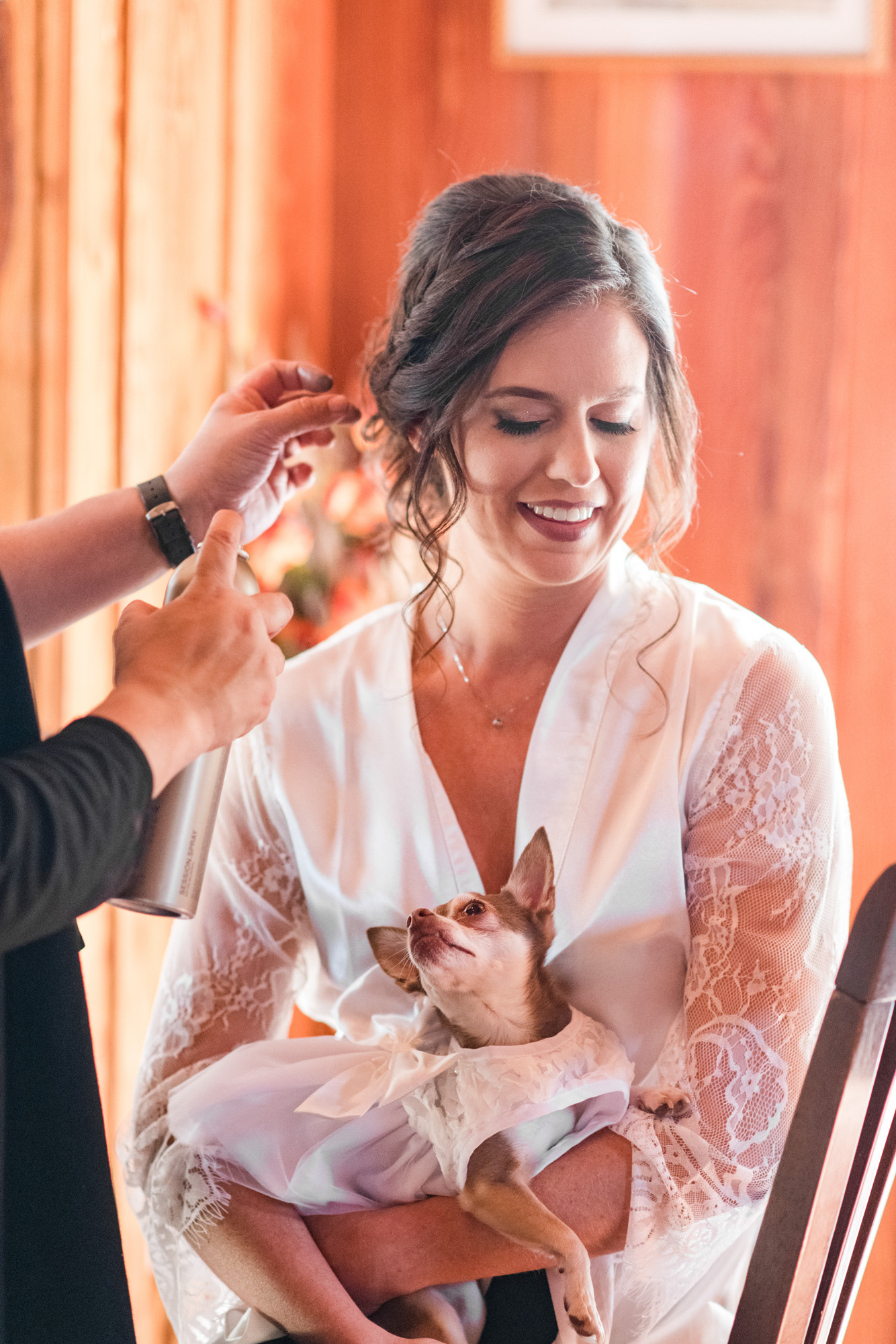Bride getting ready with her small dog in her lap before her Estate on the Halifax wedding.