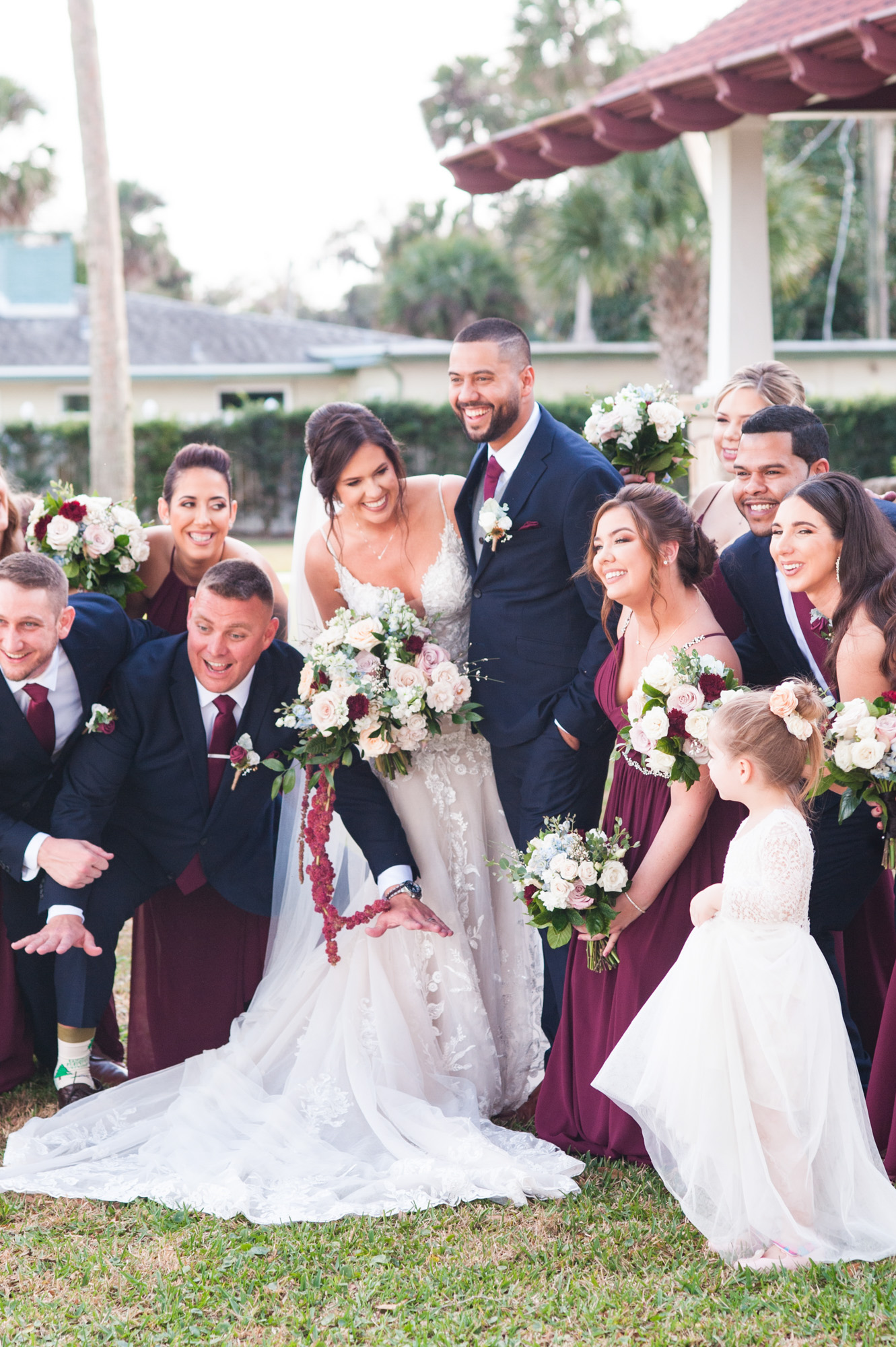Floral wedding ceremony arrangement with blush draping and burgundy accents at Estate on the Halifax.