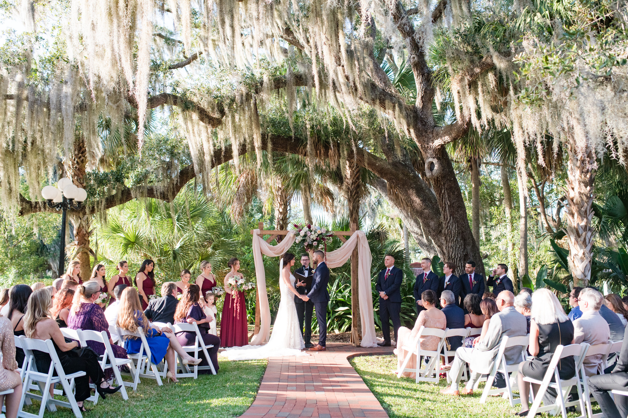 Wide view of the outdoor wedding ceremony beneath a moss-covered oak tree at Estate on the Halifax.