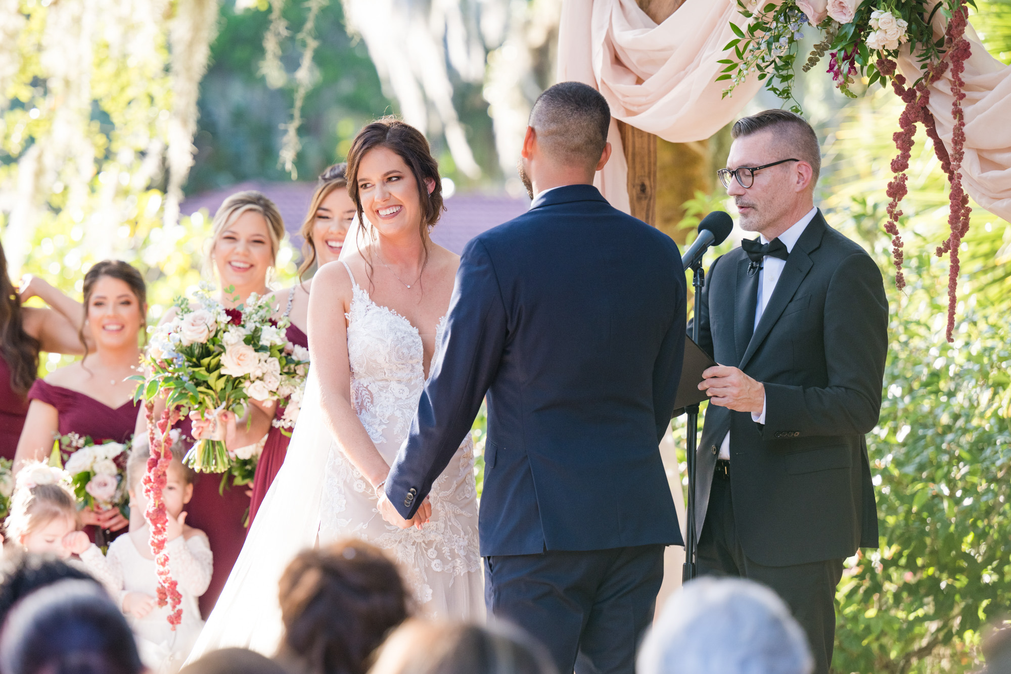 Bride smiling at the groom while the officiant speaks during the Estate on the Halifax ceremony.