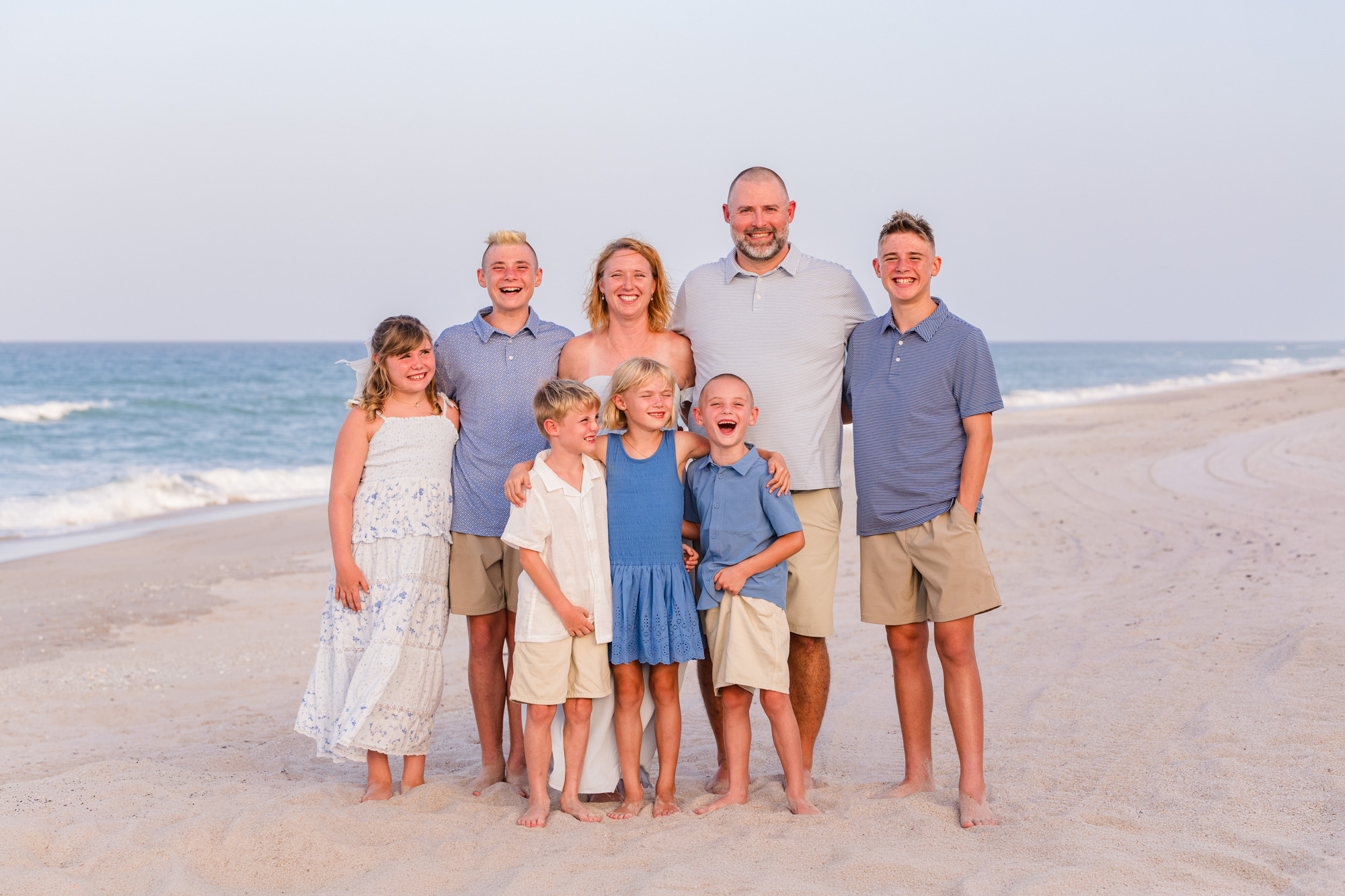 Family with six children dressed in blues and whites during their Melbourne Beach family session