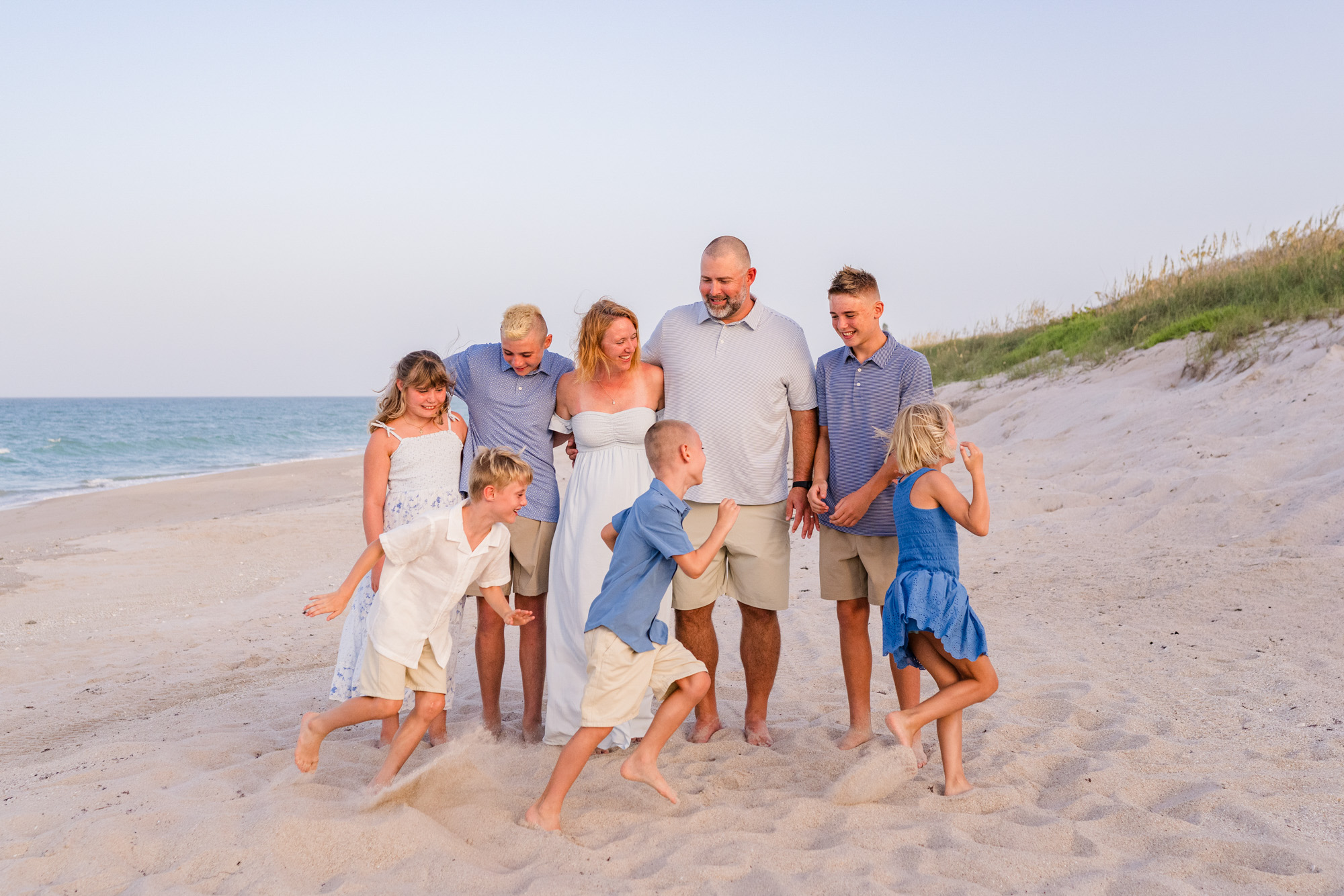 family with six children all laughing together during their Melbourne Beach Family session