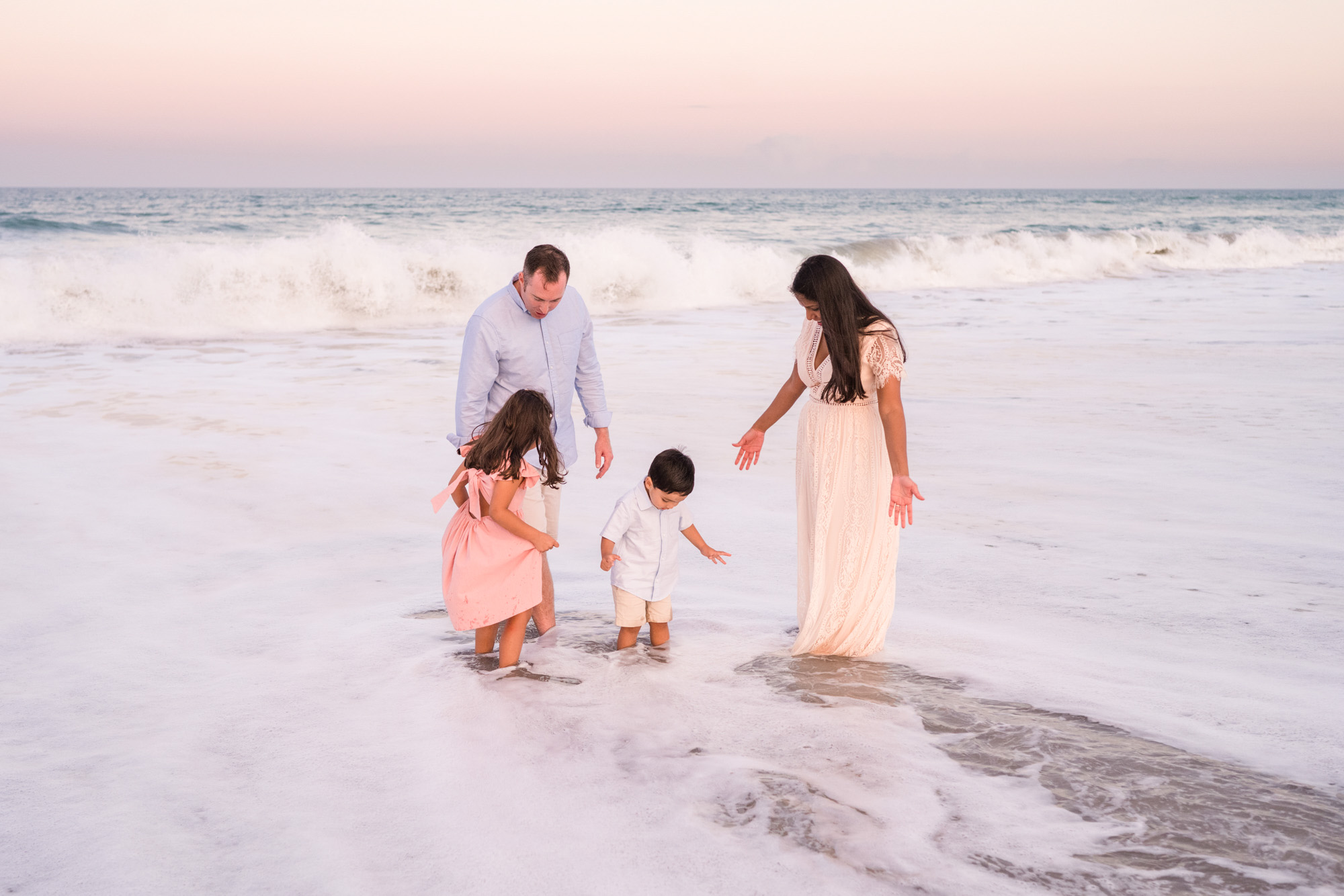 Family of four playing in the water of the Atlantic Ocean