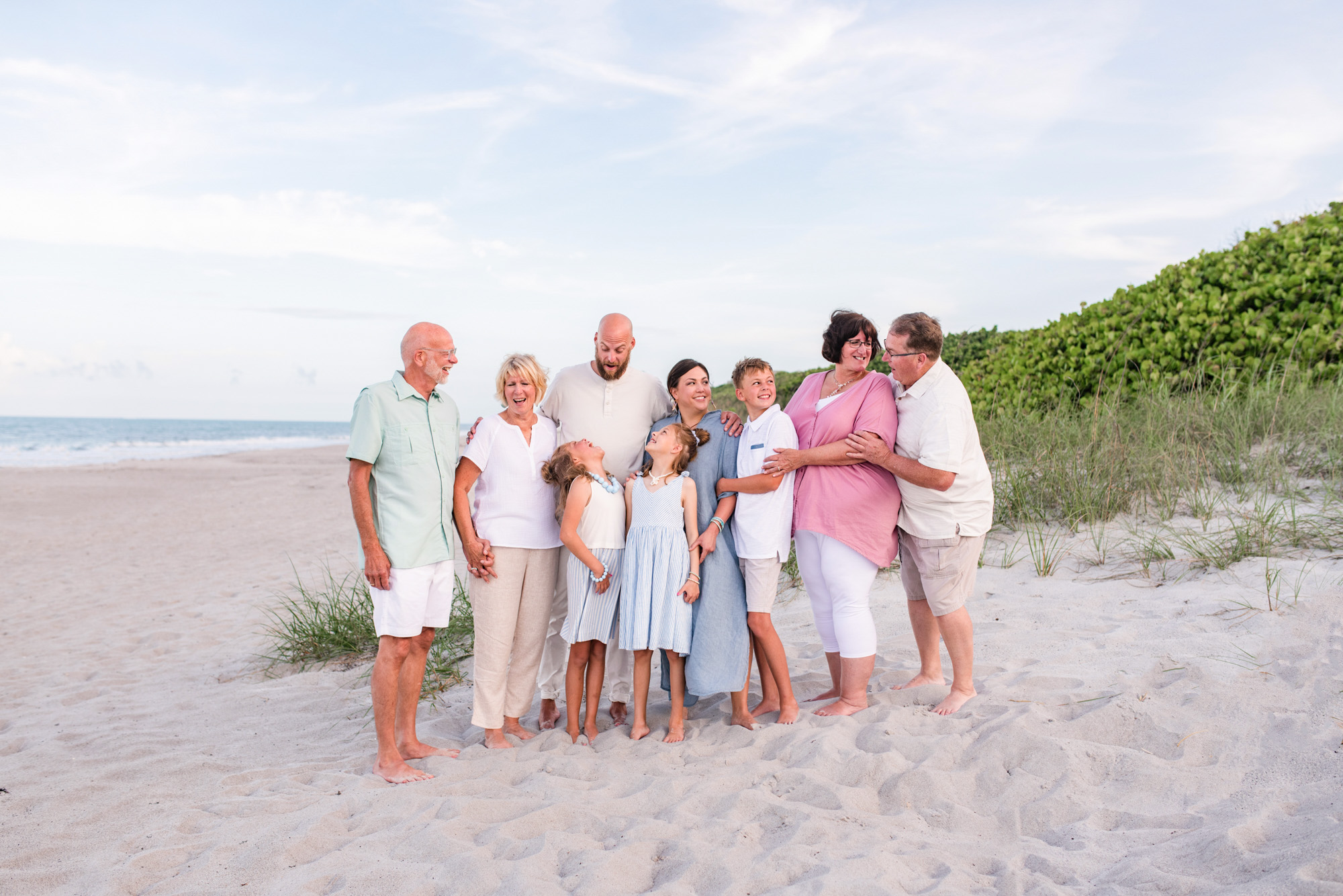 extended family dressed in soft pastels on Melbourne Beach