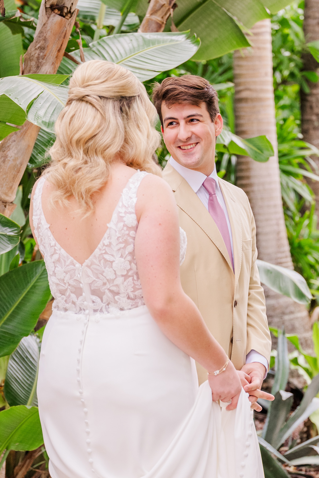 Groom smiles at the bride after seeing her for the first time on their wedding day.