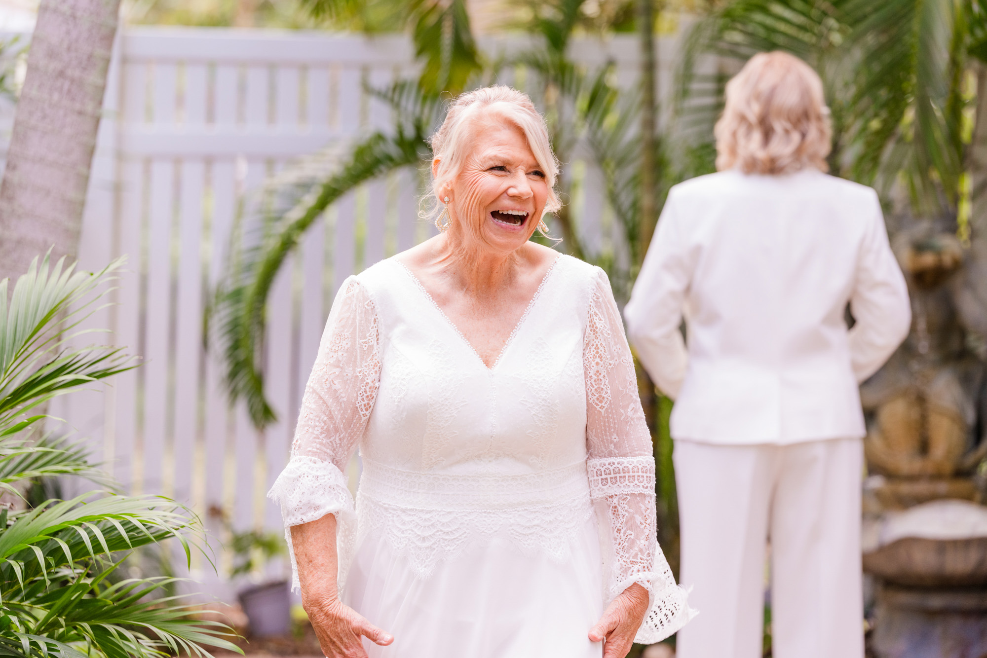 Smiling bride during a joyful first look with her partner on their wedding day.