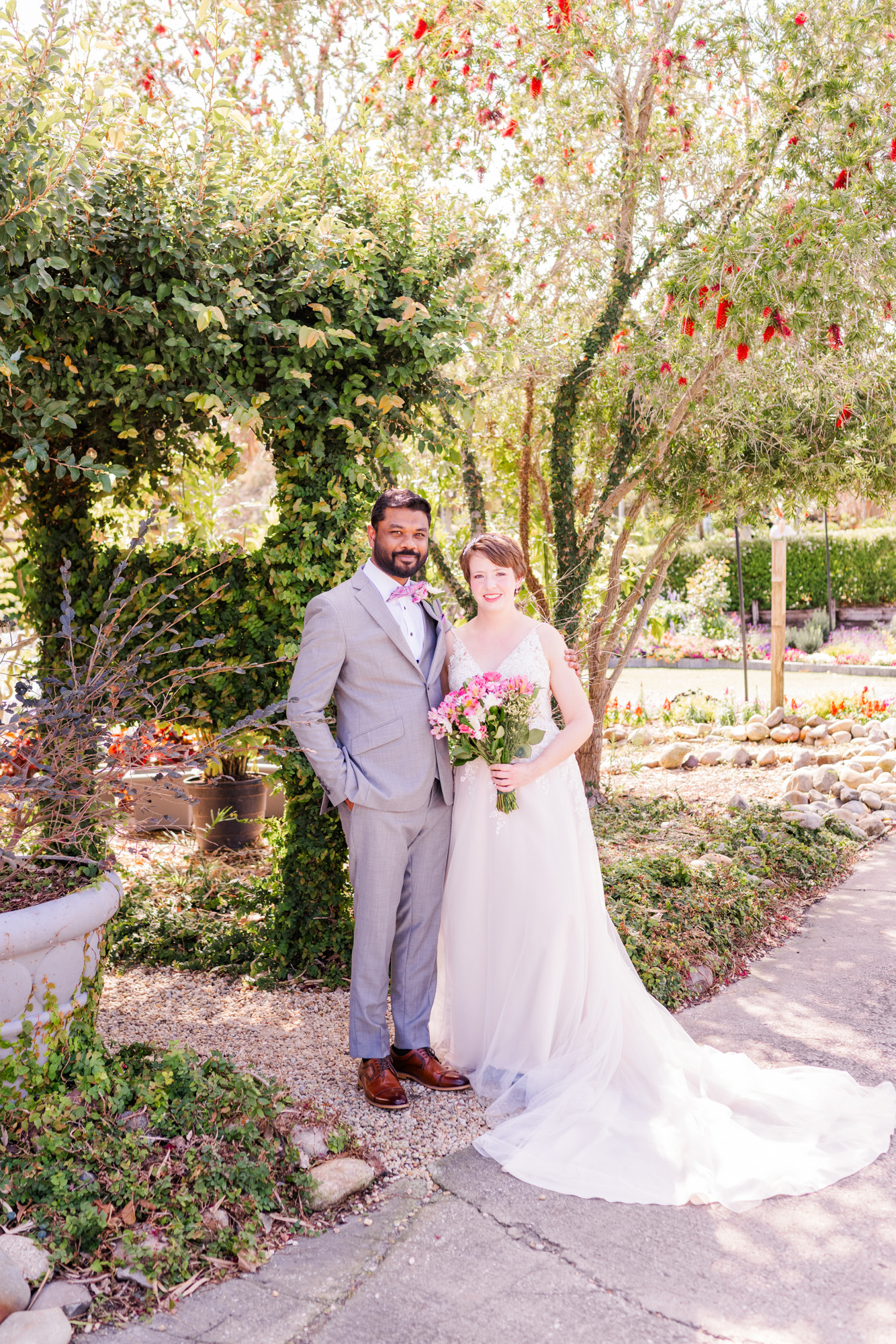 Bride and groom pose together for a portrait after their outdoor wedding first look.