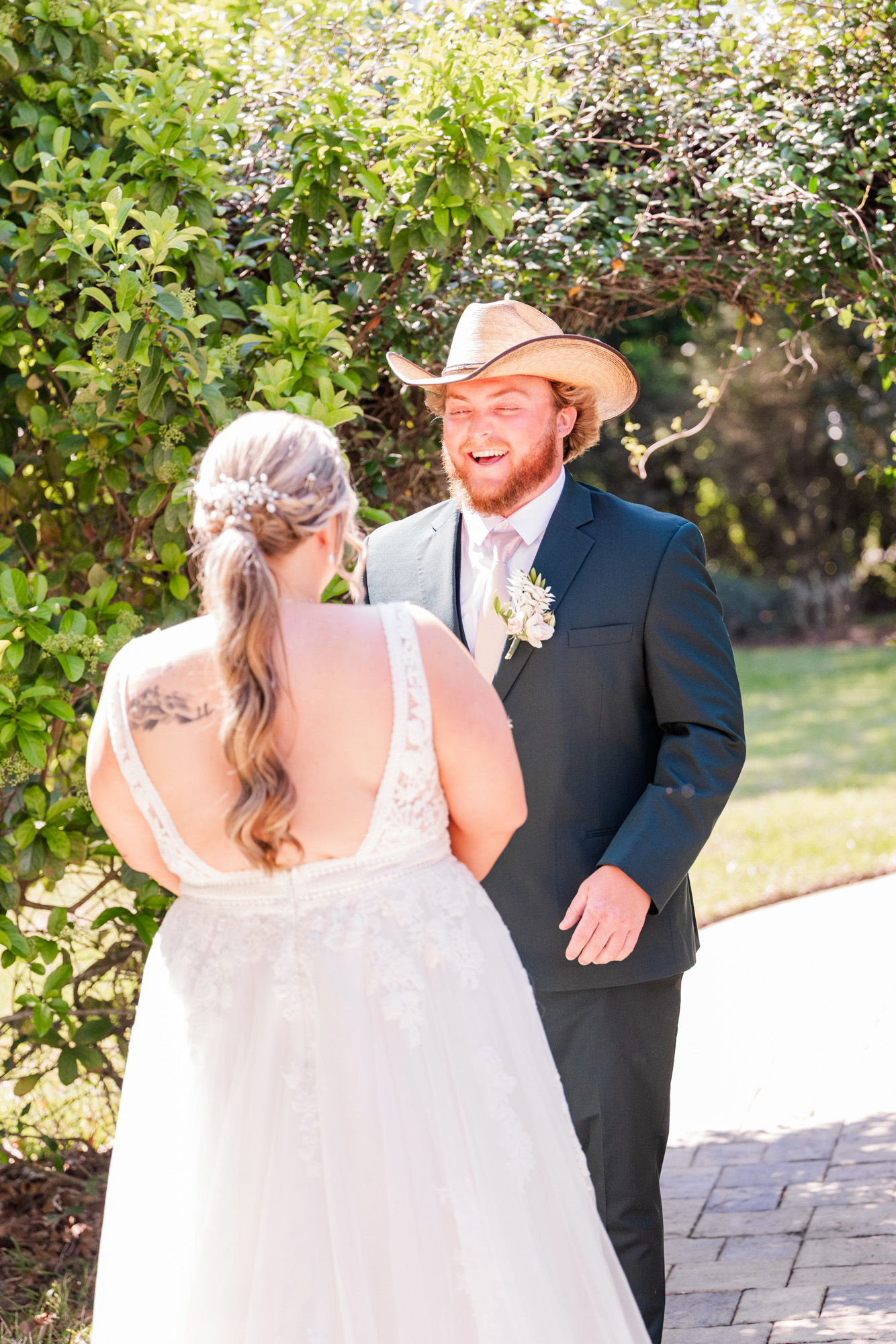 Groom reacts with excitement as he sees the bride during their wedding first look.