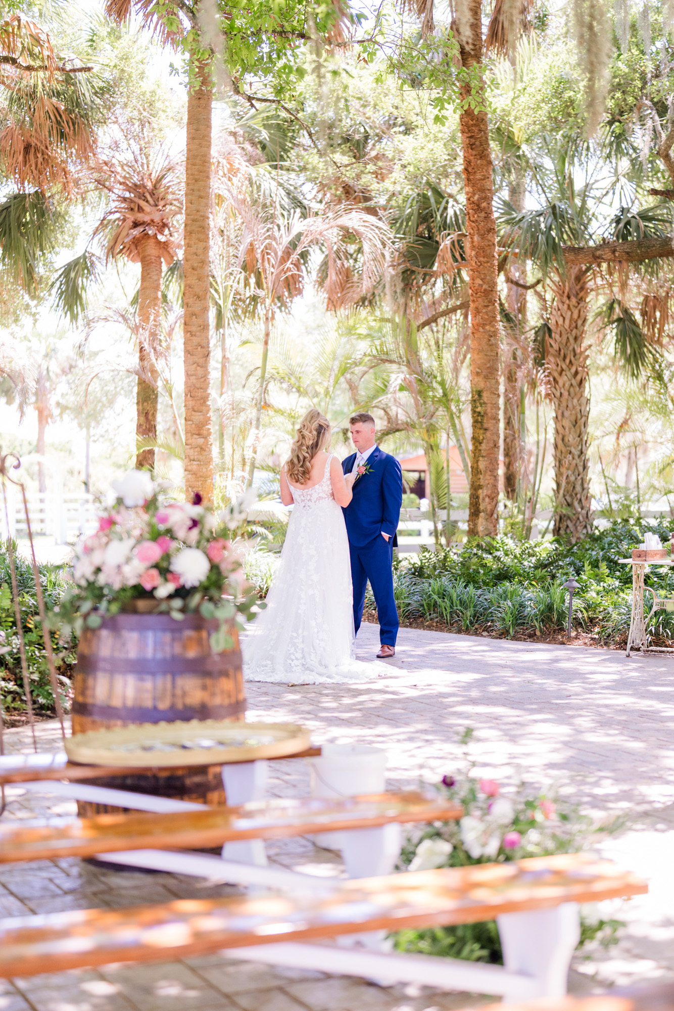 Bride reacts with excitement during an emotional wedding first look in a tropical garden.