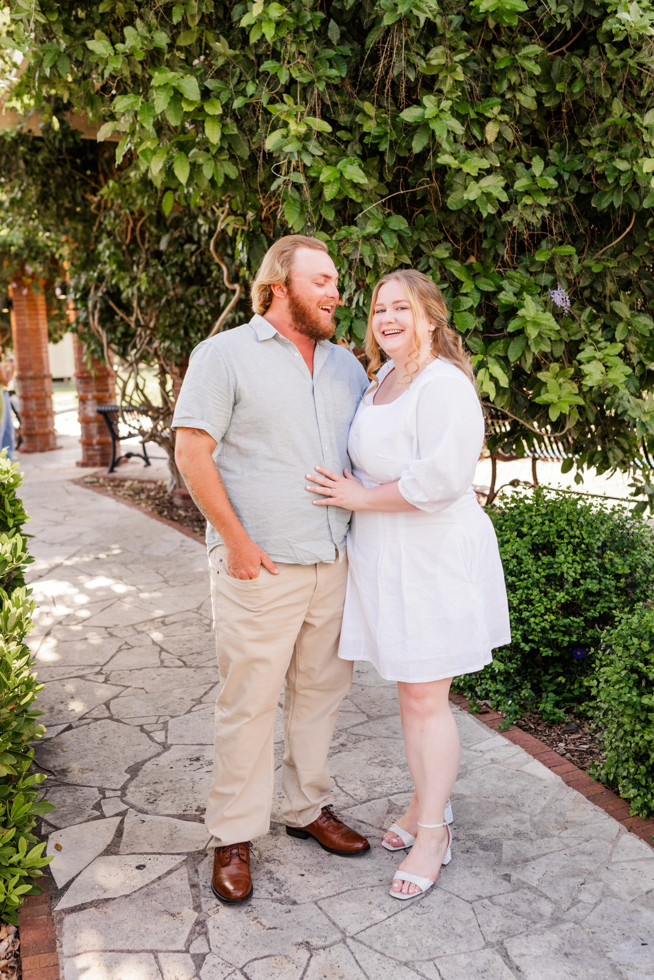 Couple hugging under trees at their Winter Park engagement session