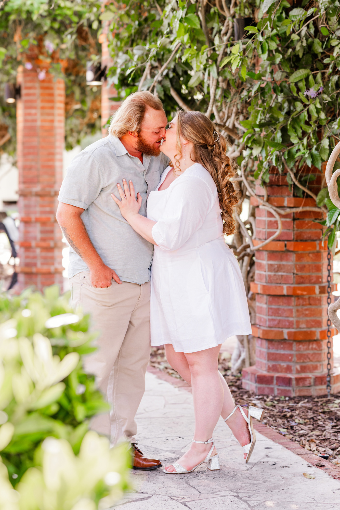 Couple kissing under trees at their Winter Park engagement session