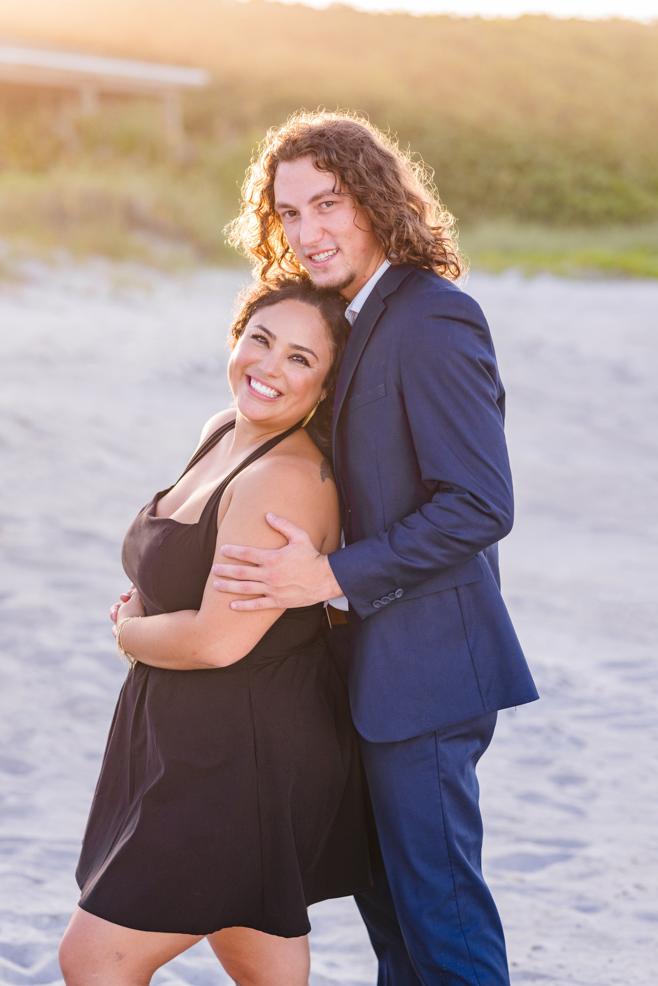 Man in Blue suit holding woman from behind on Melbourne Beach