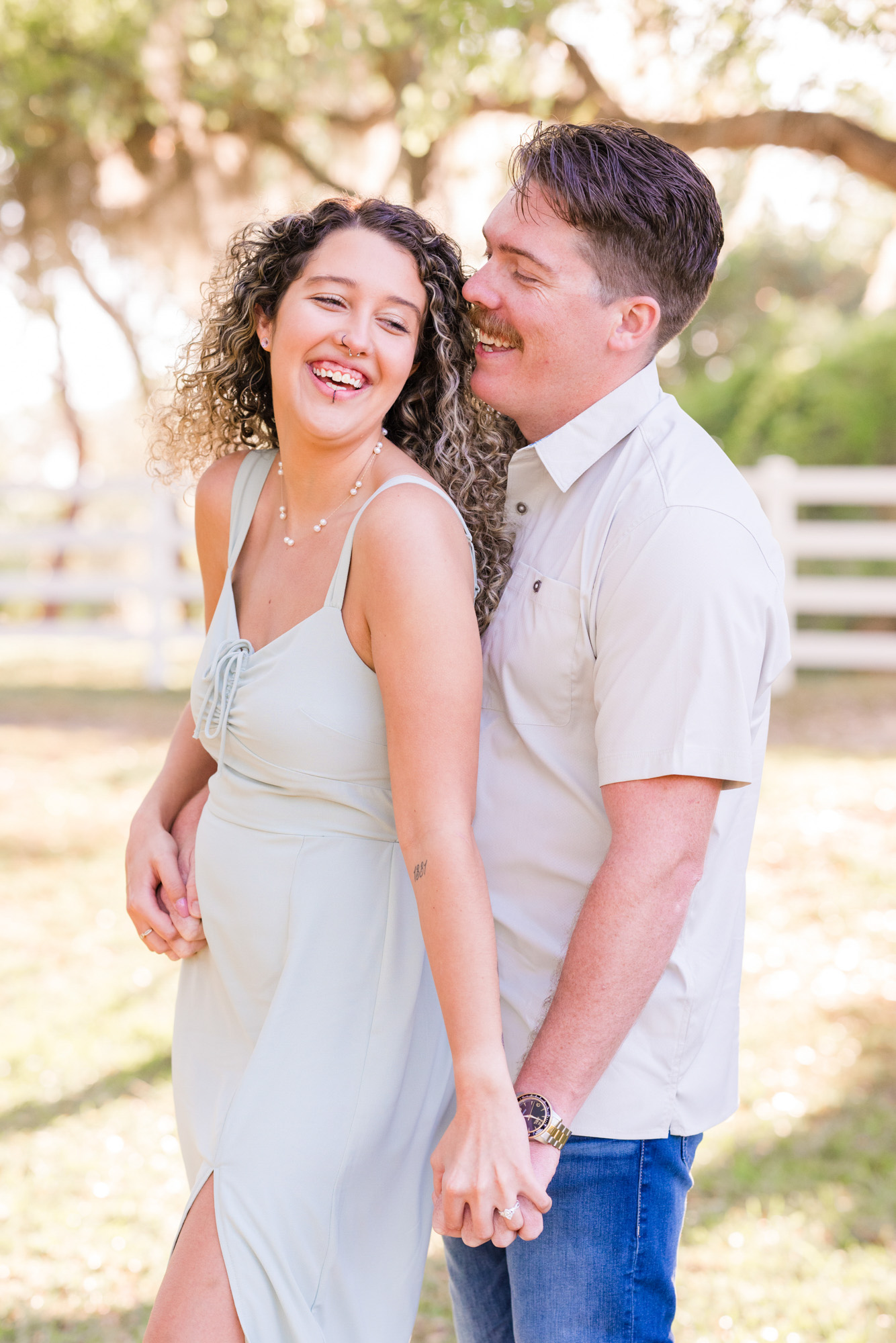 Man holding woman from behind during their Up the Creek Farms engagement session