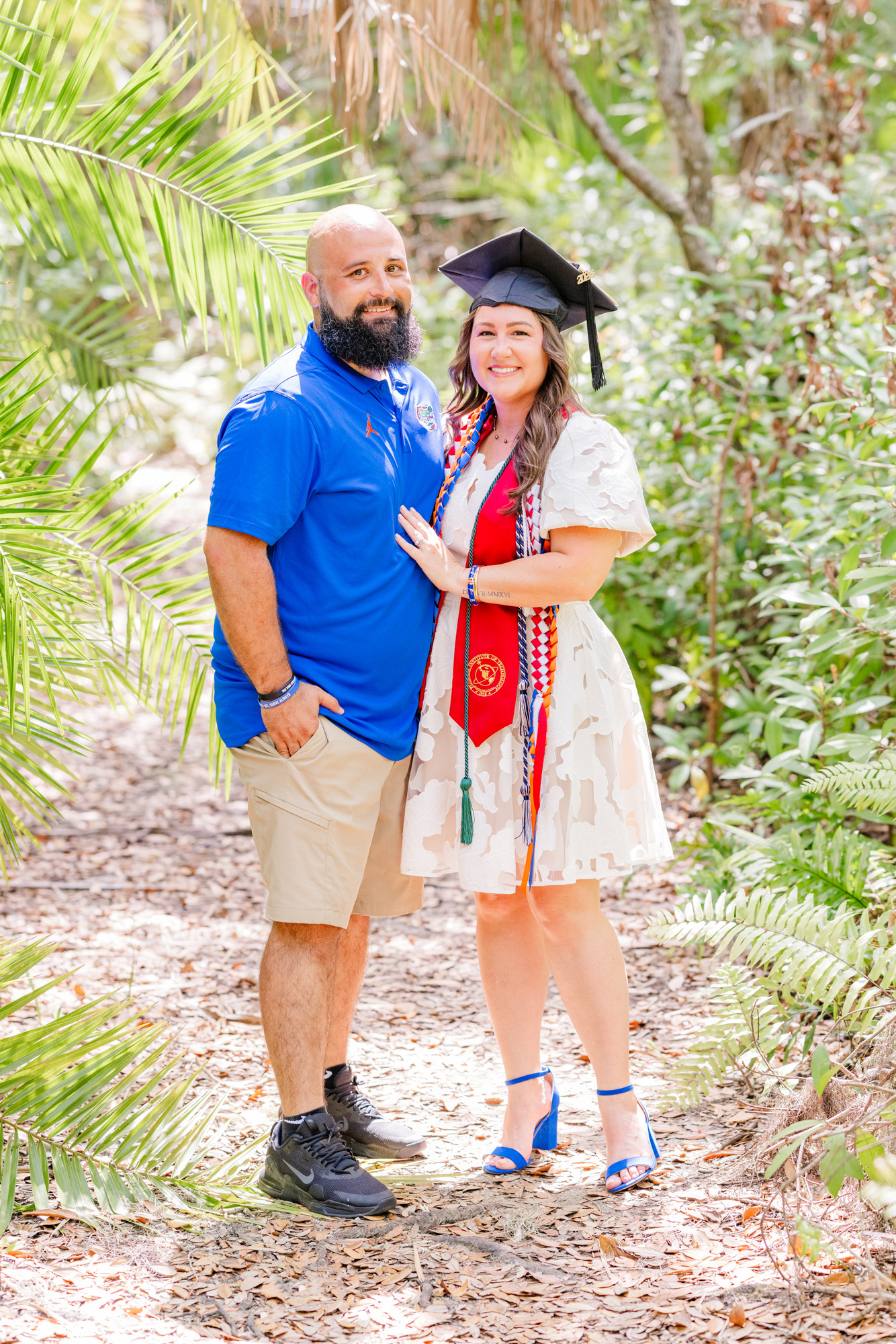 Graduate smiling with her partner during a family and graduation session.