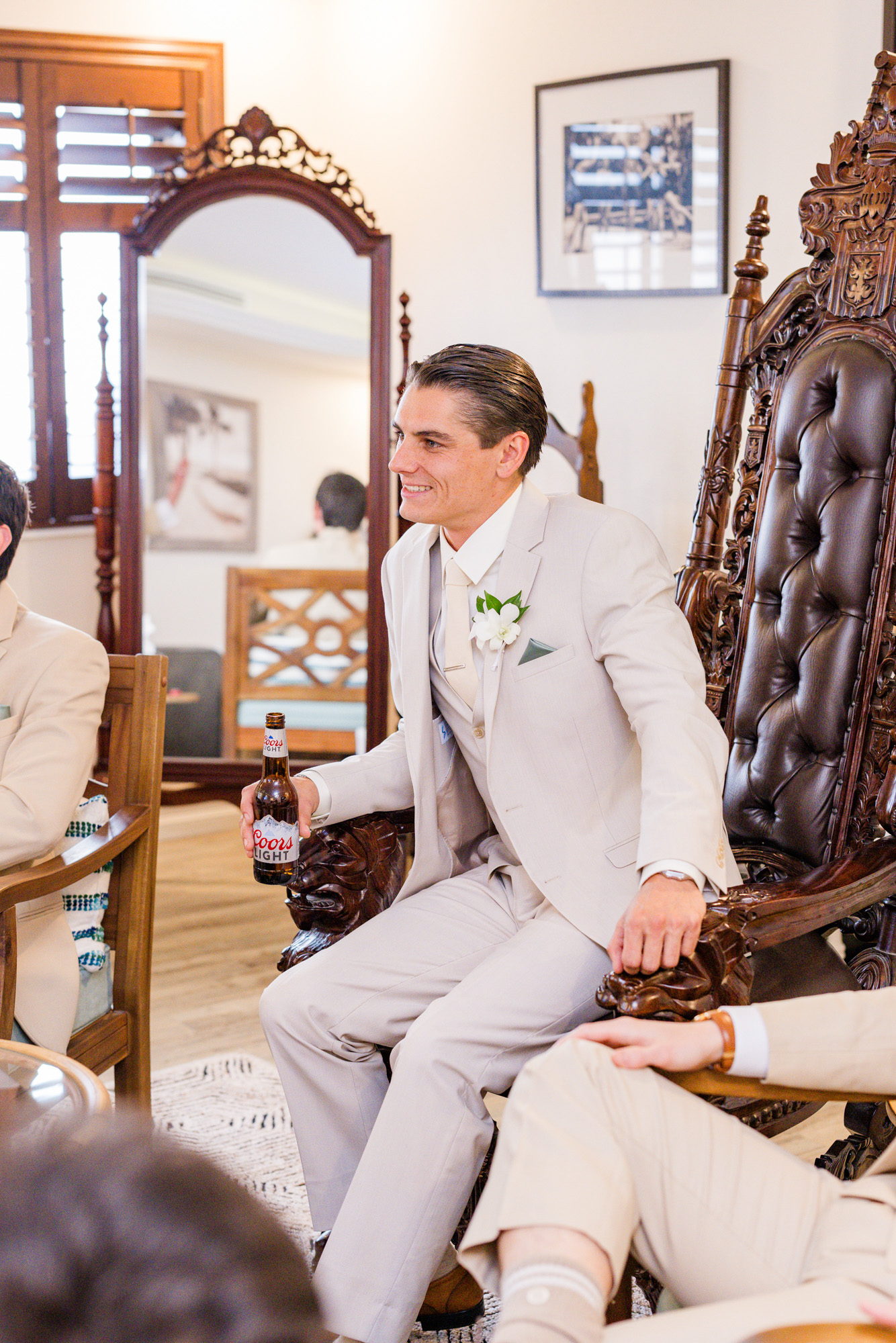 Groom sitting on a chair in the getting ready room