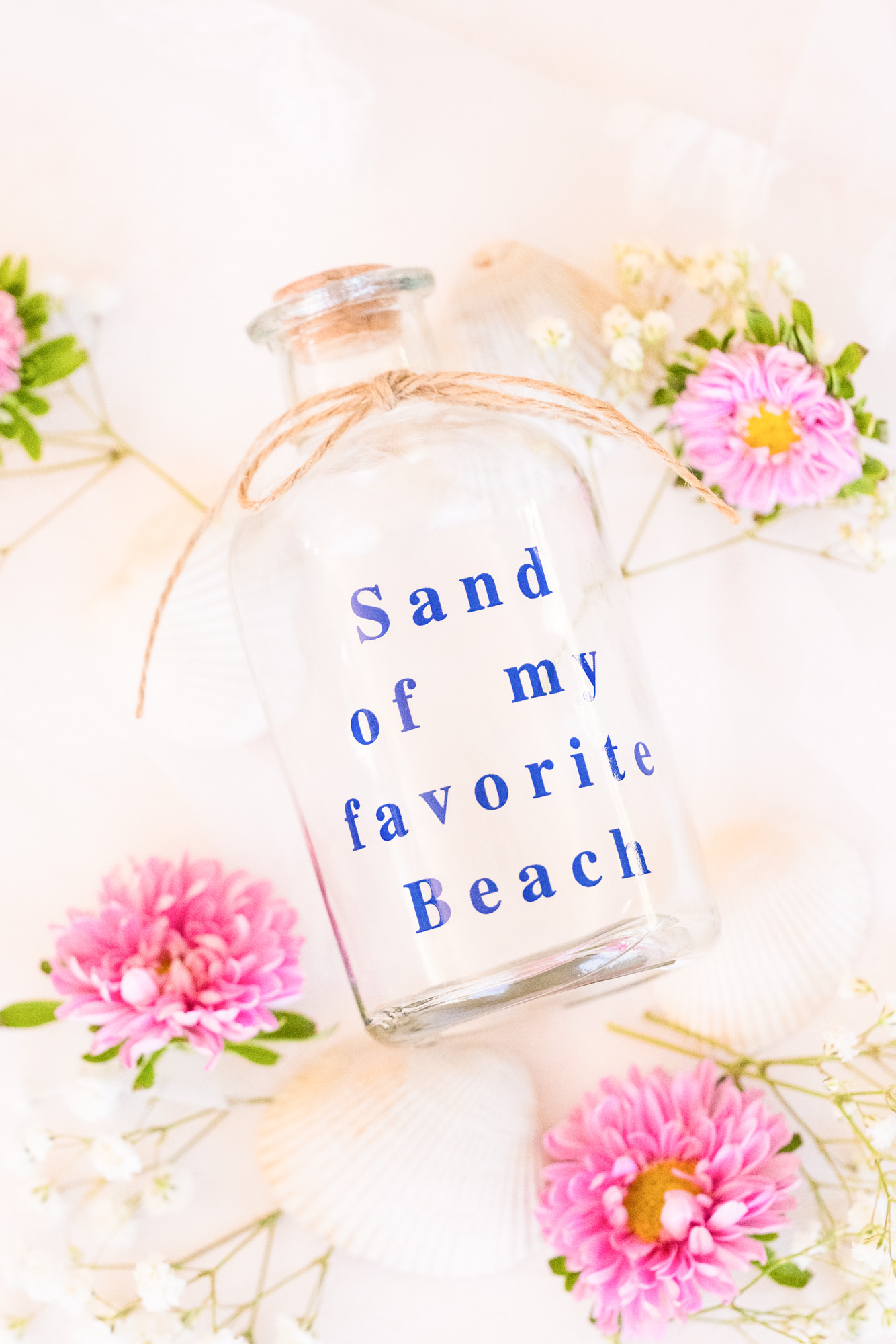 Detail photograph of a bottle that will hold sand from the couples wedding