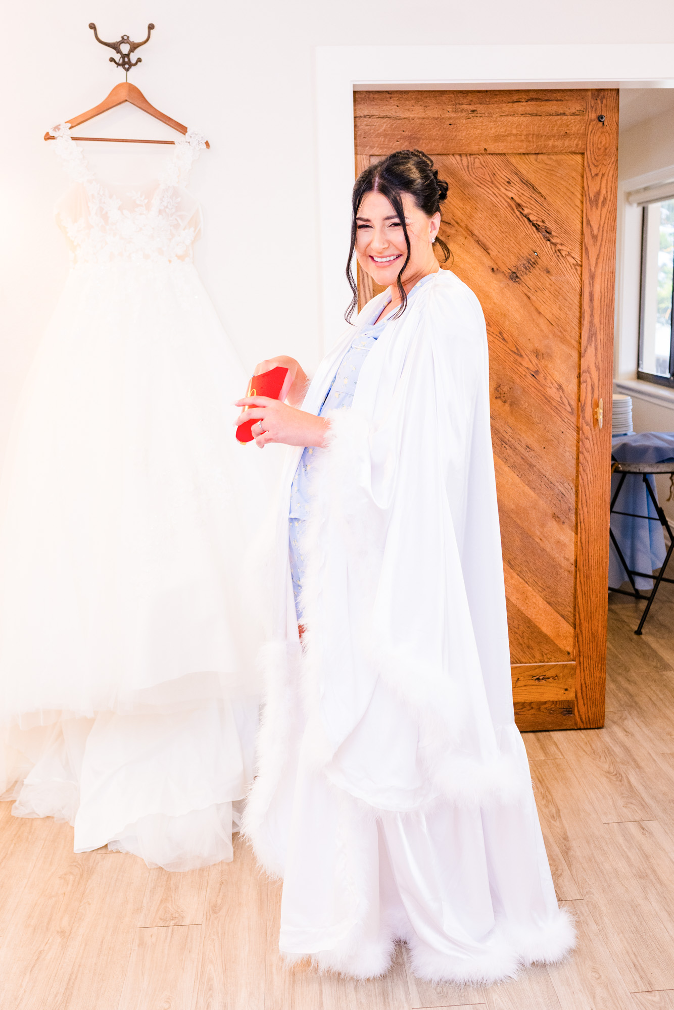 Bride in long white robe eating french fries