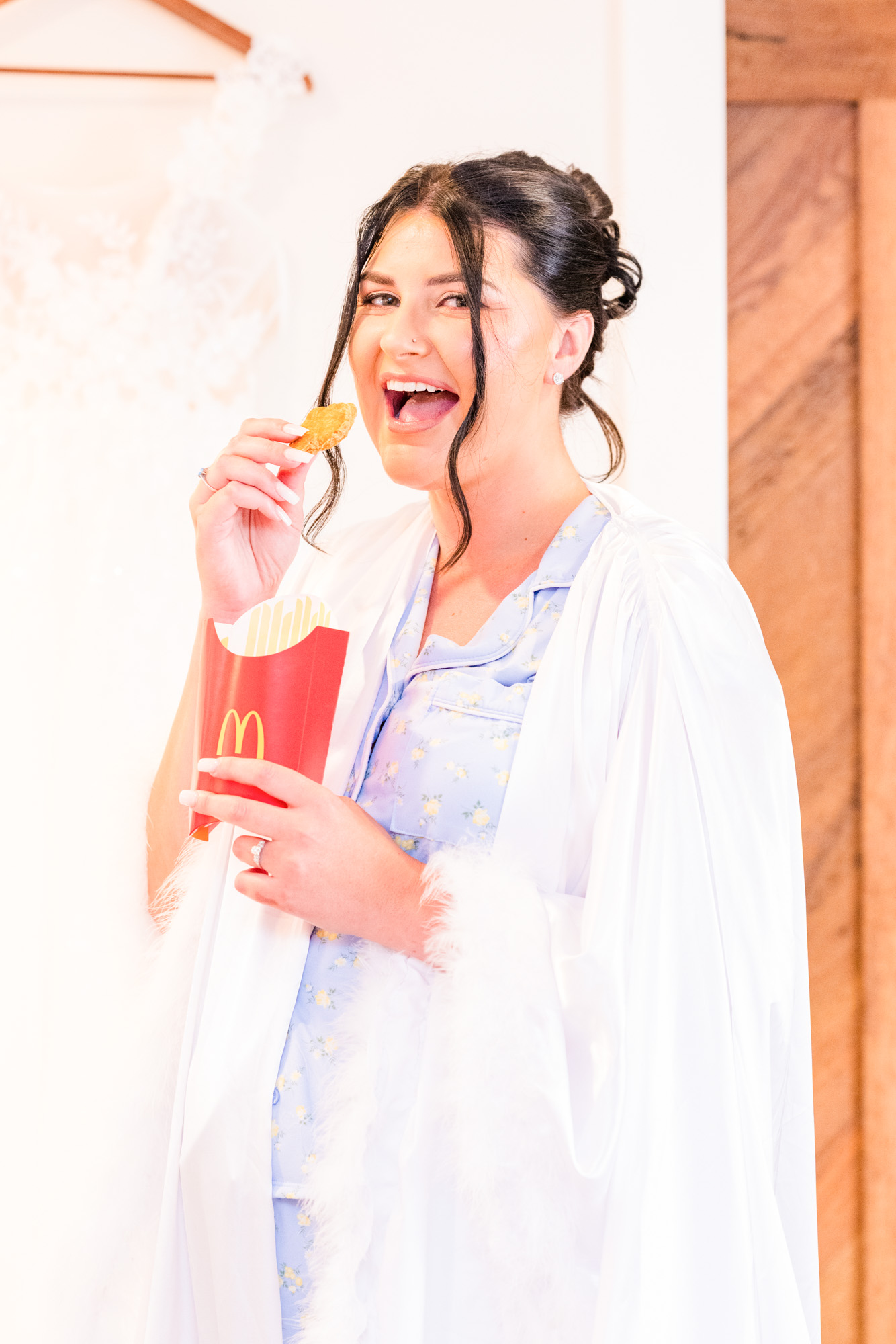 Bride eating McDonalds as she is getting ready for her wedding at Harbour House Oceanfront venue