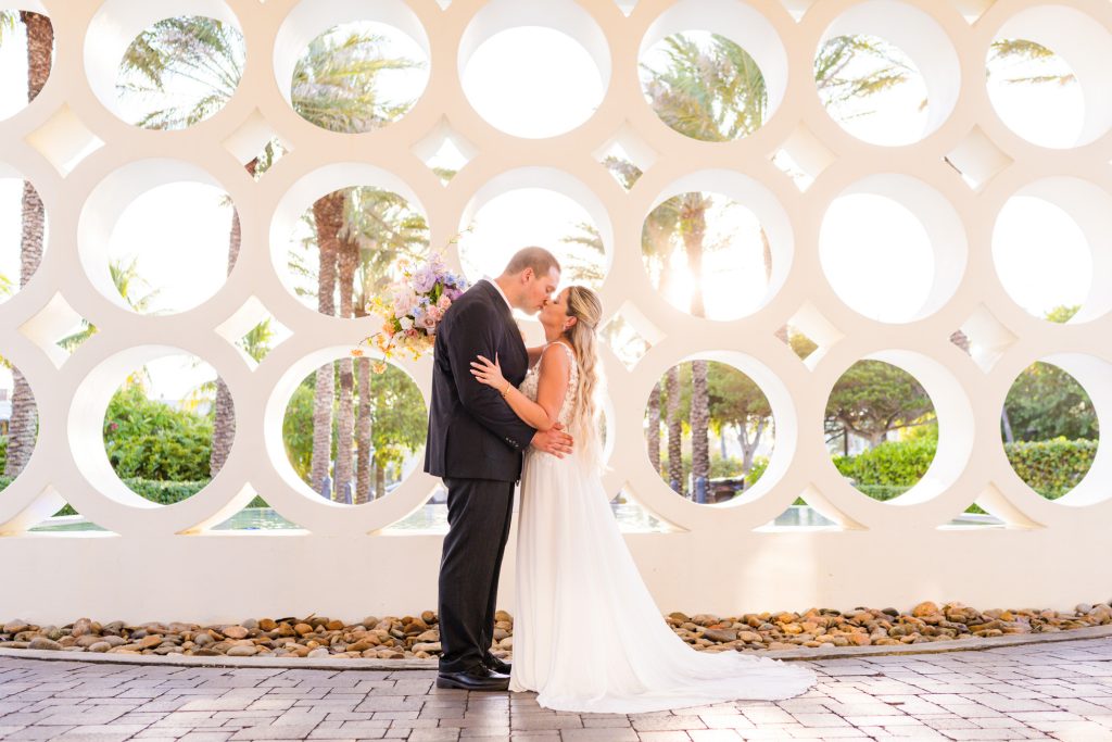 Couple kissing during elopement at Costa d'este vero beach