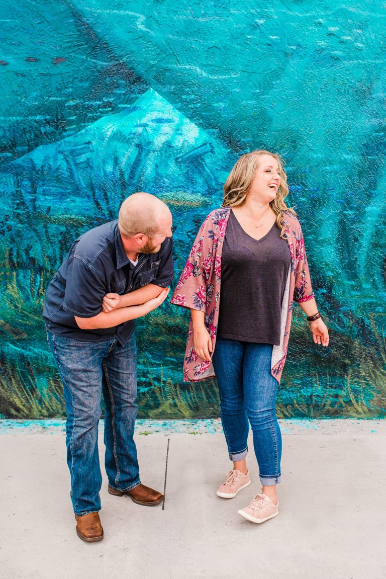 couple laughing in downtown Melbourne in front of the blue mural