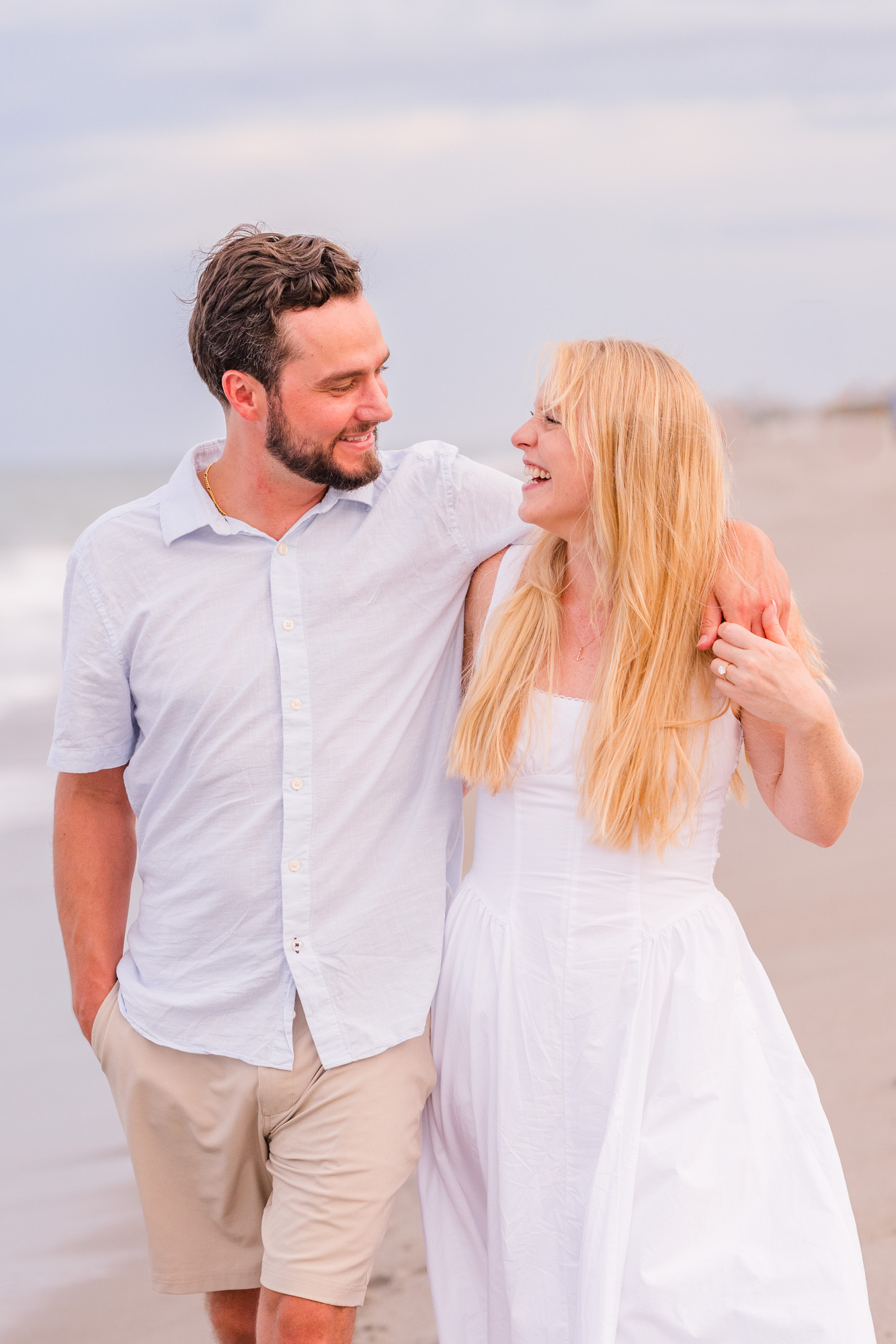 Man with arm around woman walking on Melbourne Beach