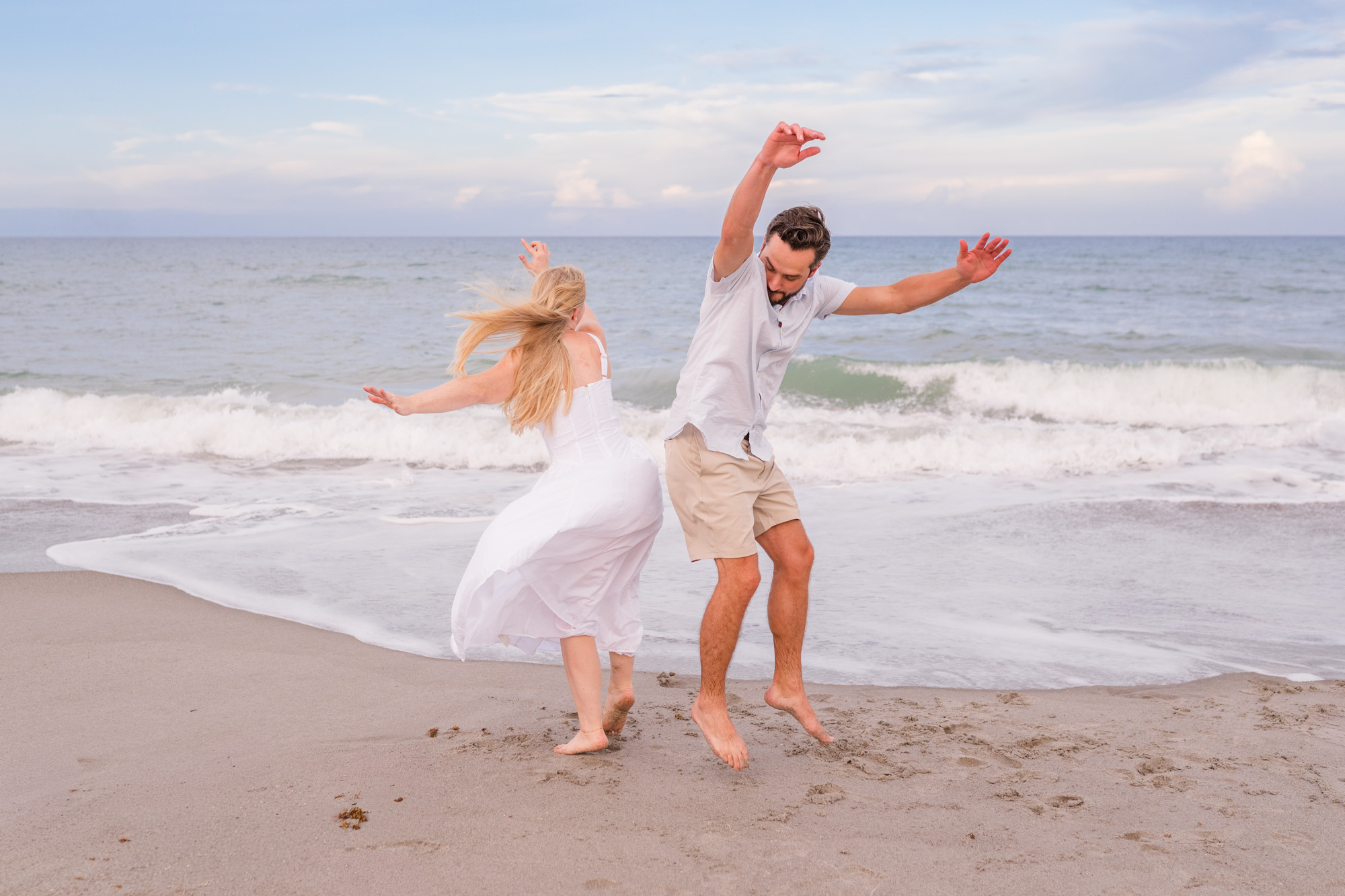 Couple bumping hips during their Melbourne Beach Engagement Session