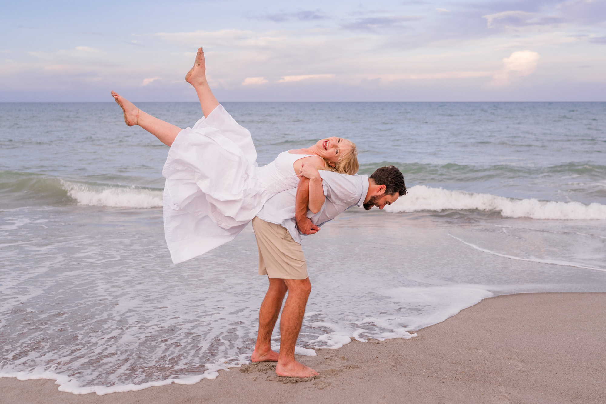 Man with woman on his back during Melbourne Beach engagement session