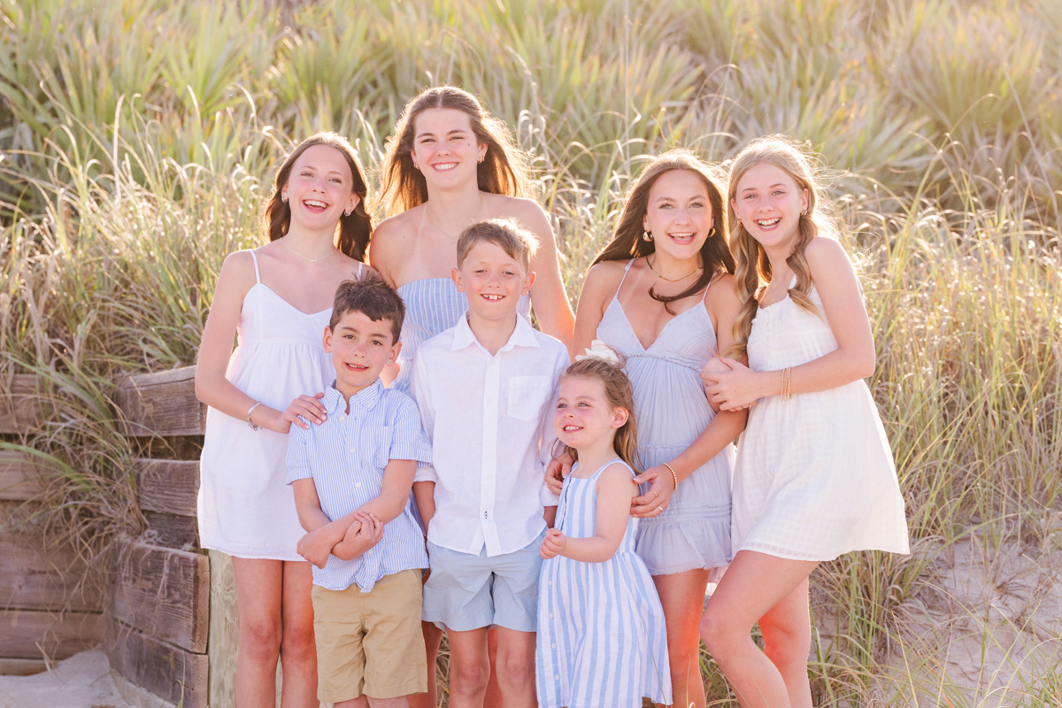 group of cousins standing in front of the dunes on melbourne beach