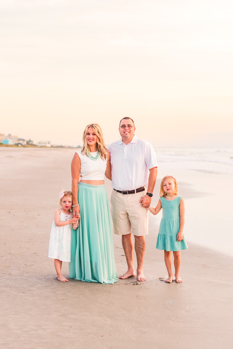 family wearing green and white during a sunrise session on melbourne beach